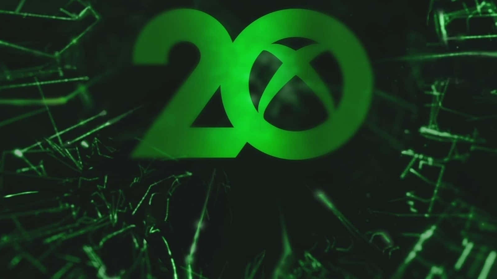 Xbox 桌布 壁紙 — 發光的綠色Xbox 20標誌在黑暗背景上透過裂紋玻璃效果閃耀。