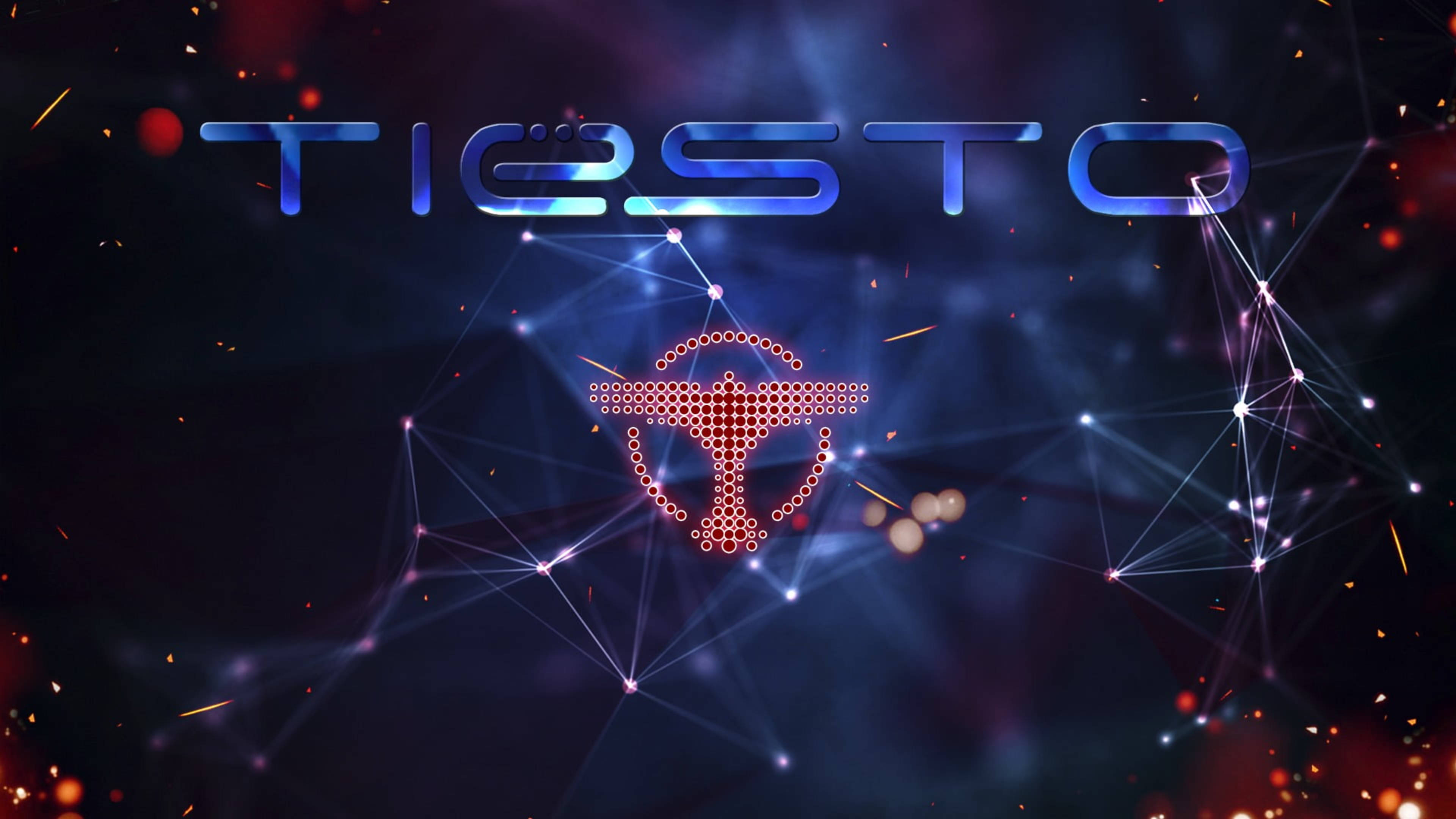 提雅斯多 桌布 壁紙 — 發光的藍色「TIËSTO」文字和紅色雞尾酒杯圖示在黑暗的宇宙背景中，漂浮在閃爍的粒子和發光的網路線條之間。