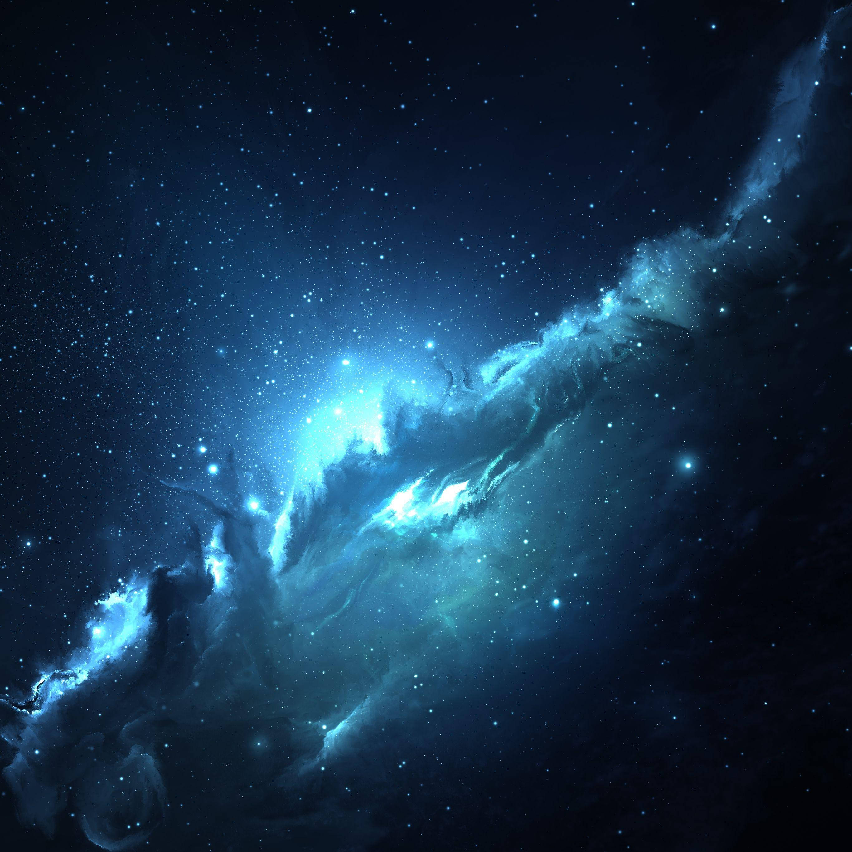 iPad Pro 桌布 壁紙 — 發光的藍色星雲在點綴著無數閃爍星星的深空中旋轉。