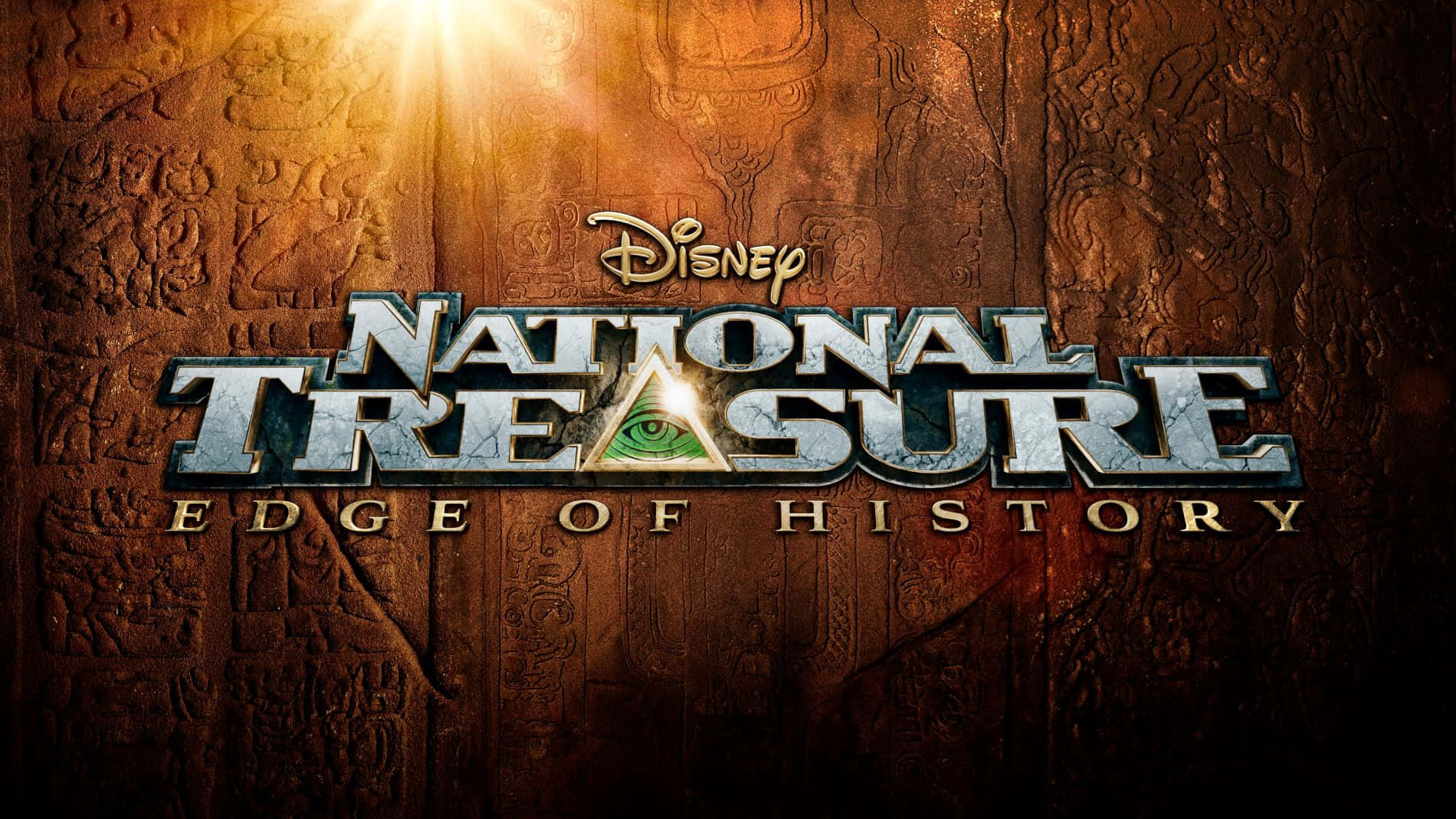 National Treasure 桌布 壁紙 — 發光的金色光線穿過古老雕刻的石頭，照射在國家寶藏電影標題標誌的後面。