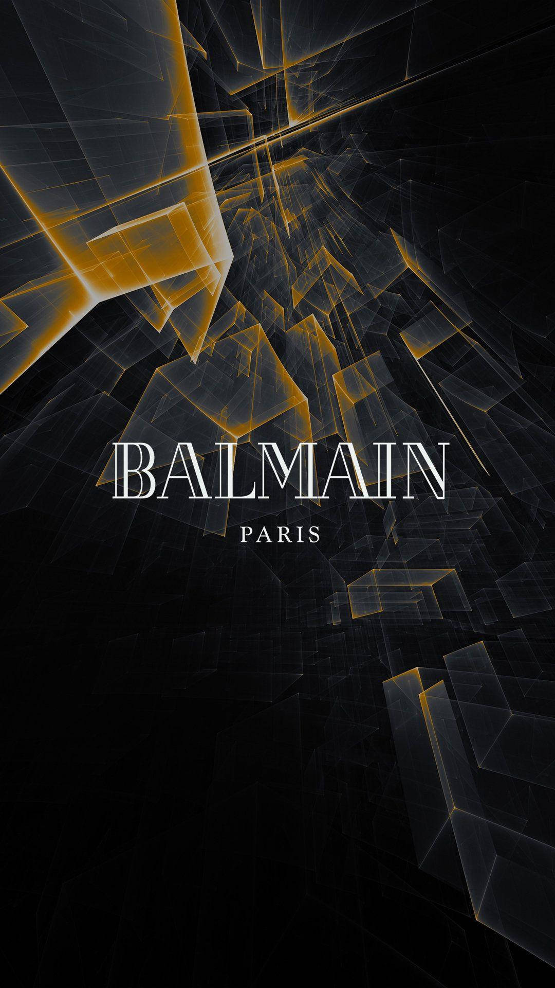 桌布 壁紙 — 發光的金色抽象幾何形狀漂浮在深黑色背景上，帶有「BALMAIN PARIS」文字。