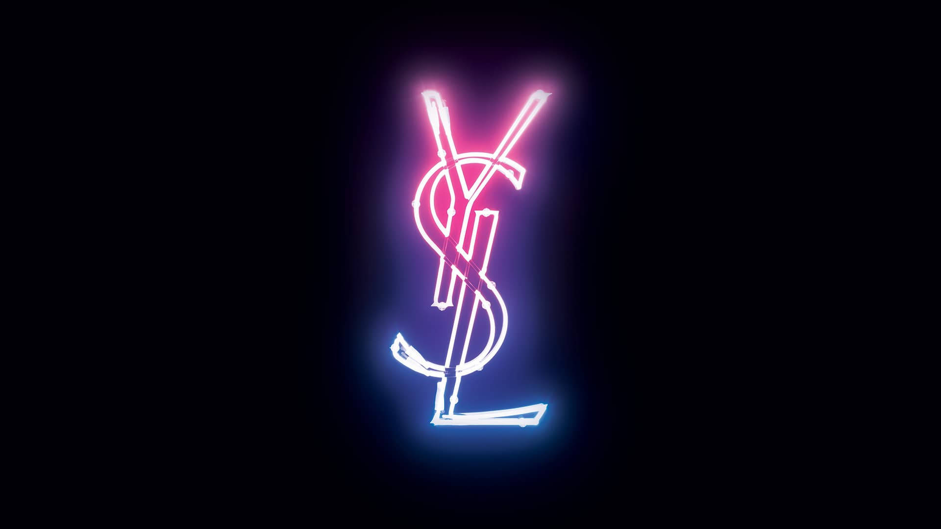 Ysl 桌布 壁紙 — 發光的霓虹YSL標誌在漆黑背景上散發出粉紅色和藍色的光芒。
