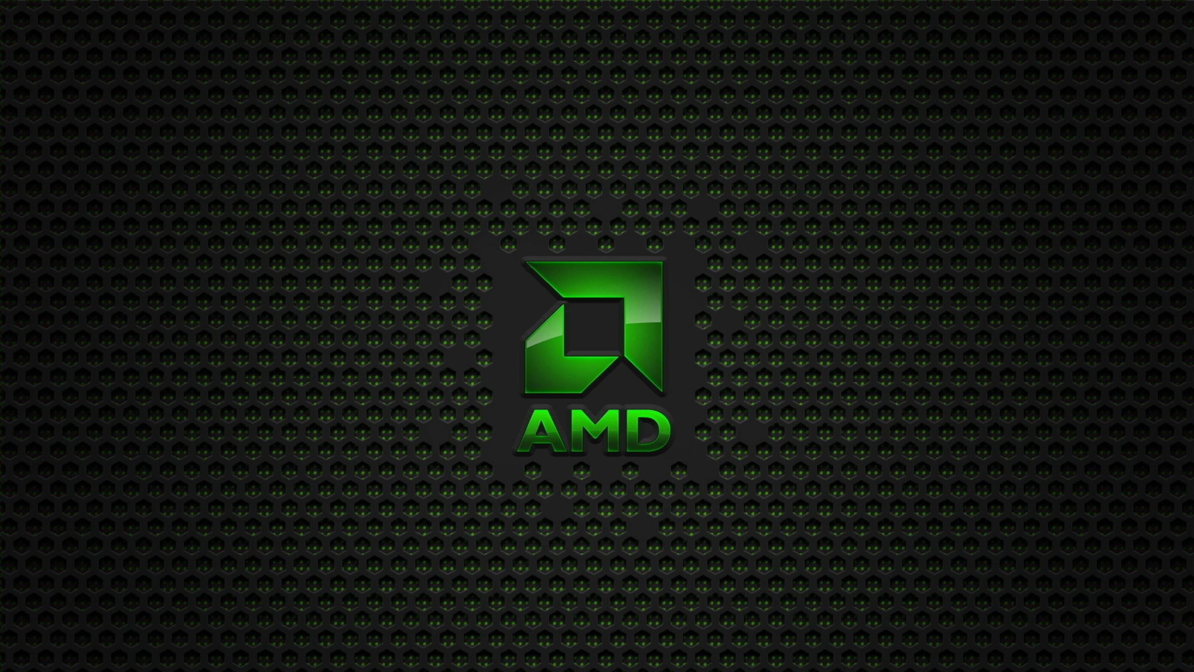 AMD 桌布 壁紙 — 發光綠色AMD標誌居中於深色穿孔金屬紋理上，帶有微妙的光線反射。