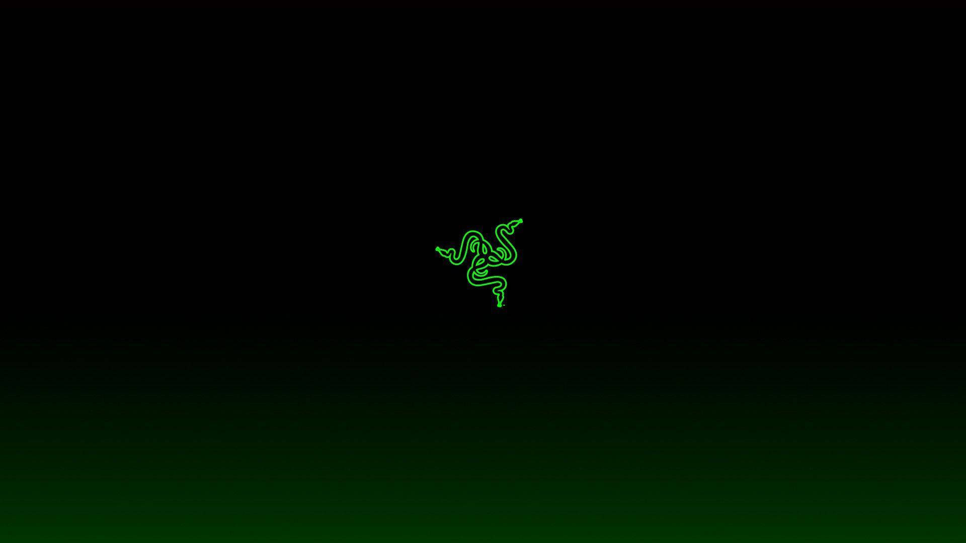 雷蛇 桌布 壁紙 — 發光綠色Razer標誌居中於從黑色過渡到深綠色的暗色漸變背景上。