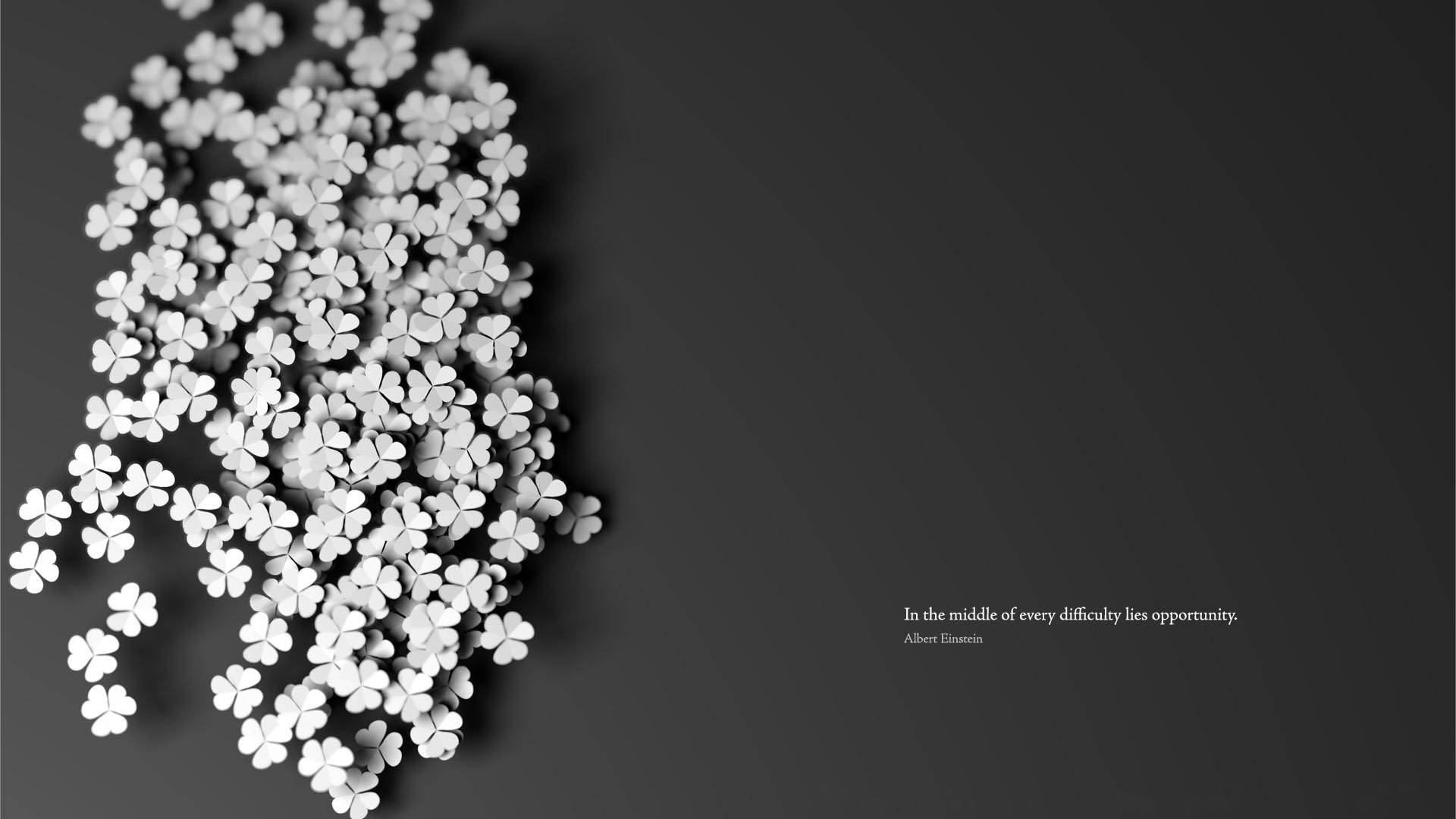 Inspirational Quotes 桌布 壁紙 — 白色3D四葉草以對角線方式排列，背景為深灰色漸變，並附有簡約字體的勵志語句。