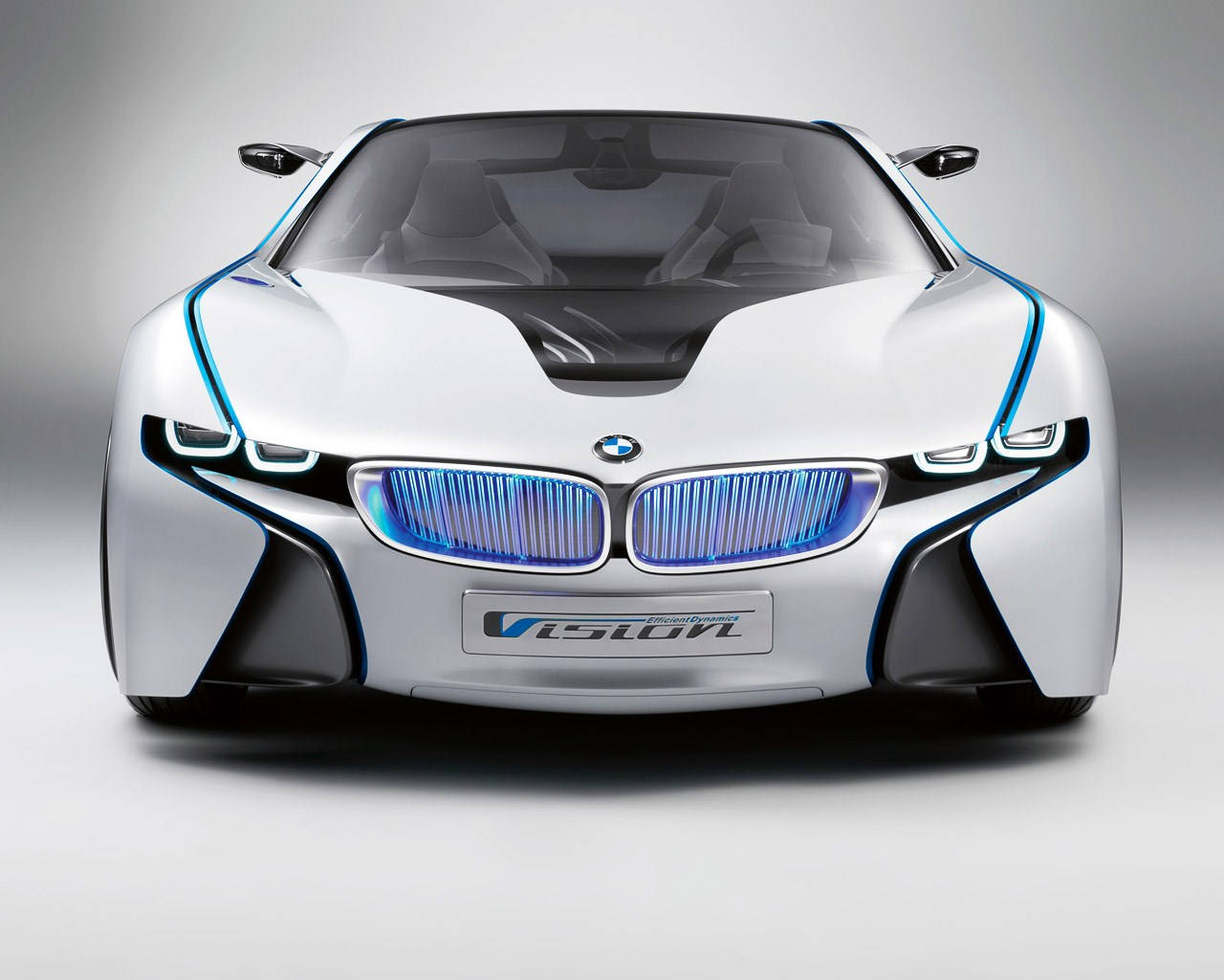 白色 桌布 壁紙 — 白色BMW i Vision概念車的正面視圖，帶有發光藍色飾邊和未來感車頭燈。