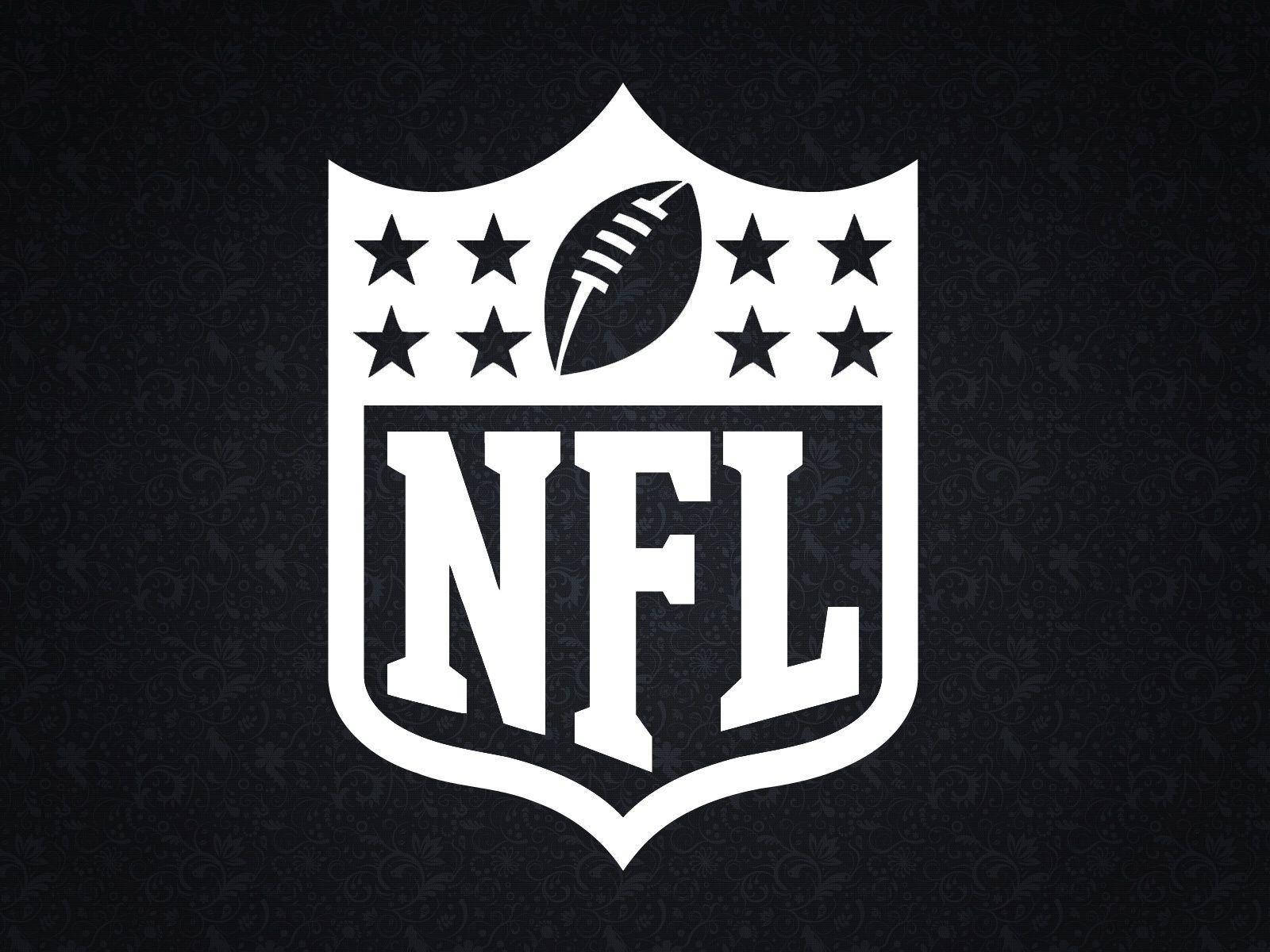 NFL Teams 桌布 壁紙 — 白色NFL盾牌標誌，中央有星星和足球，置於深色紋理背景上。