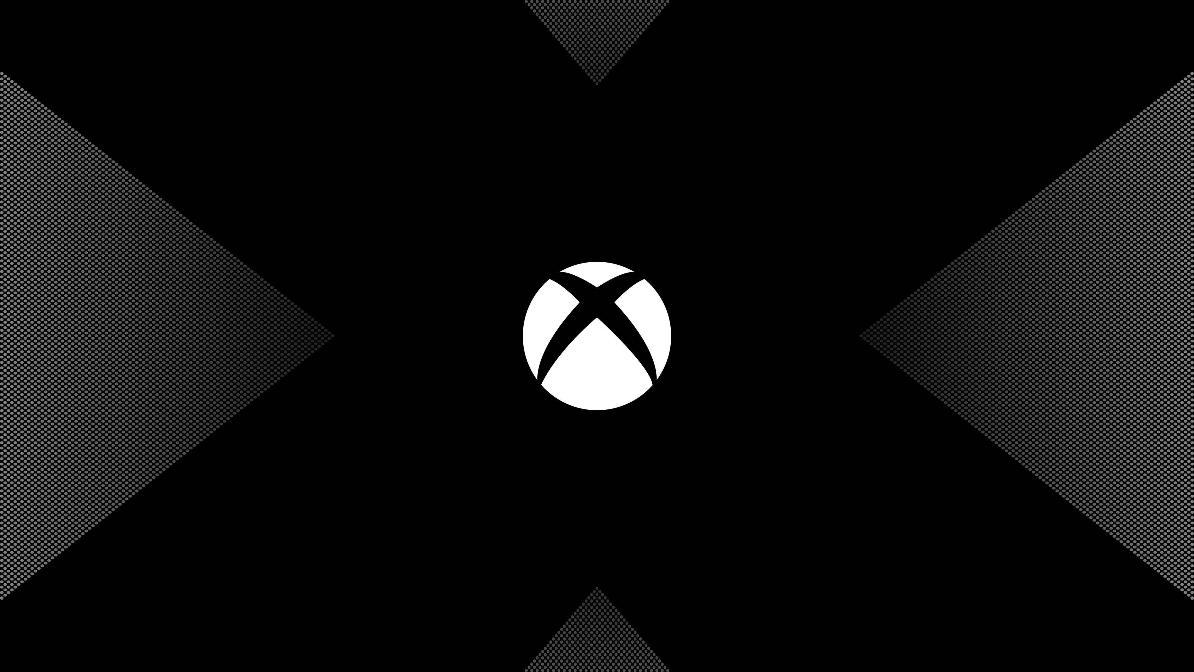 Xbox 桌布 壁紙 — 白色Xbox標誌居中於黑色背景上，帶有向外輻射的半色調漸變三角形。