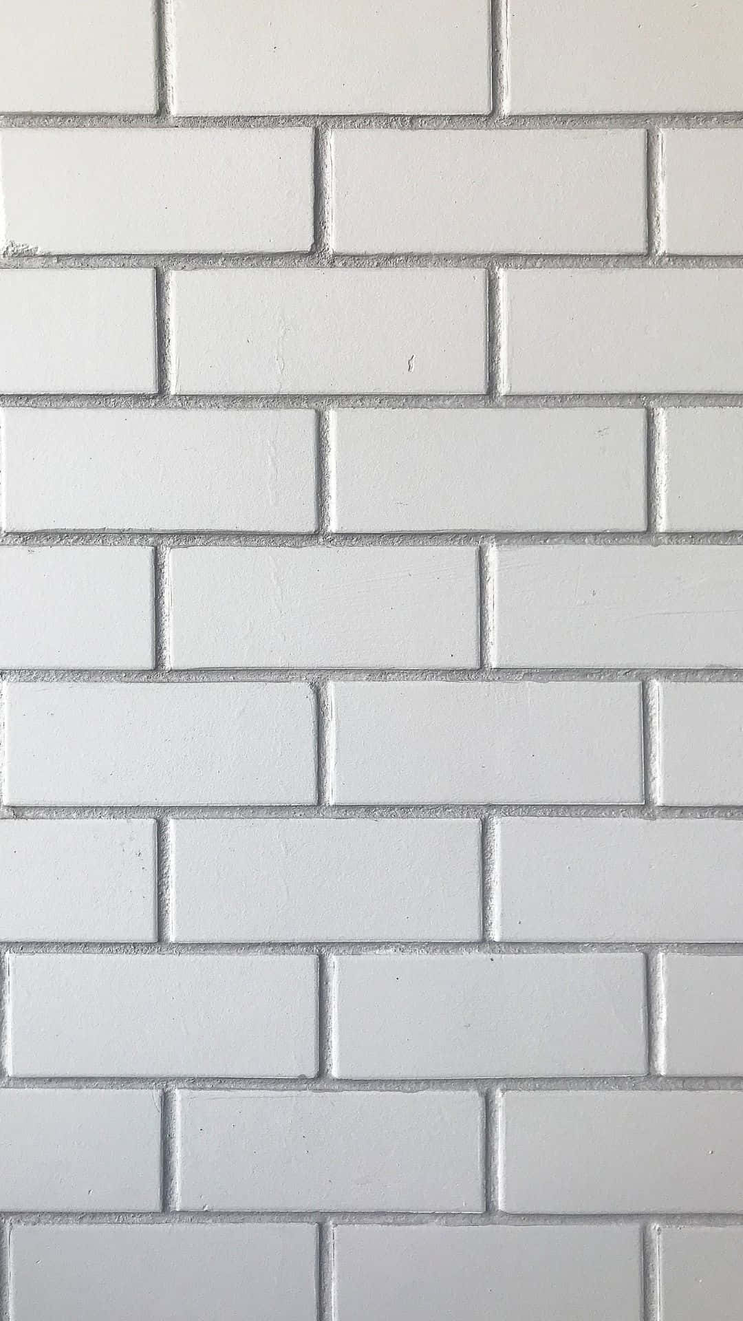 White Brick 桌布 壁紙 — 白色地鐵磚近距離特寫，灰色填縫劑以經典的工字鋪法排列。