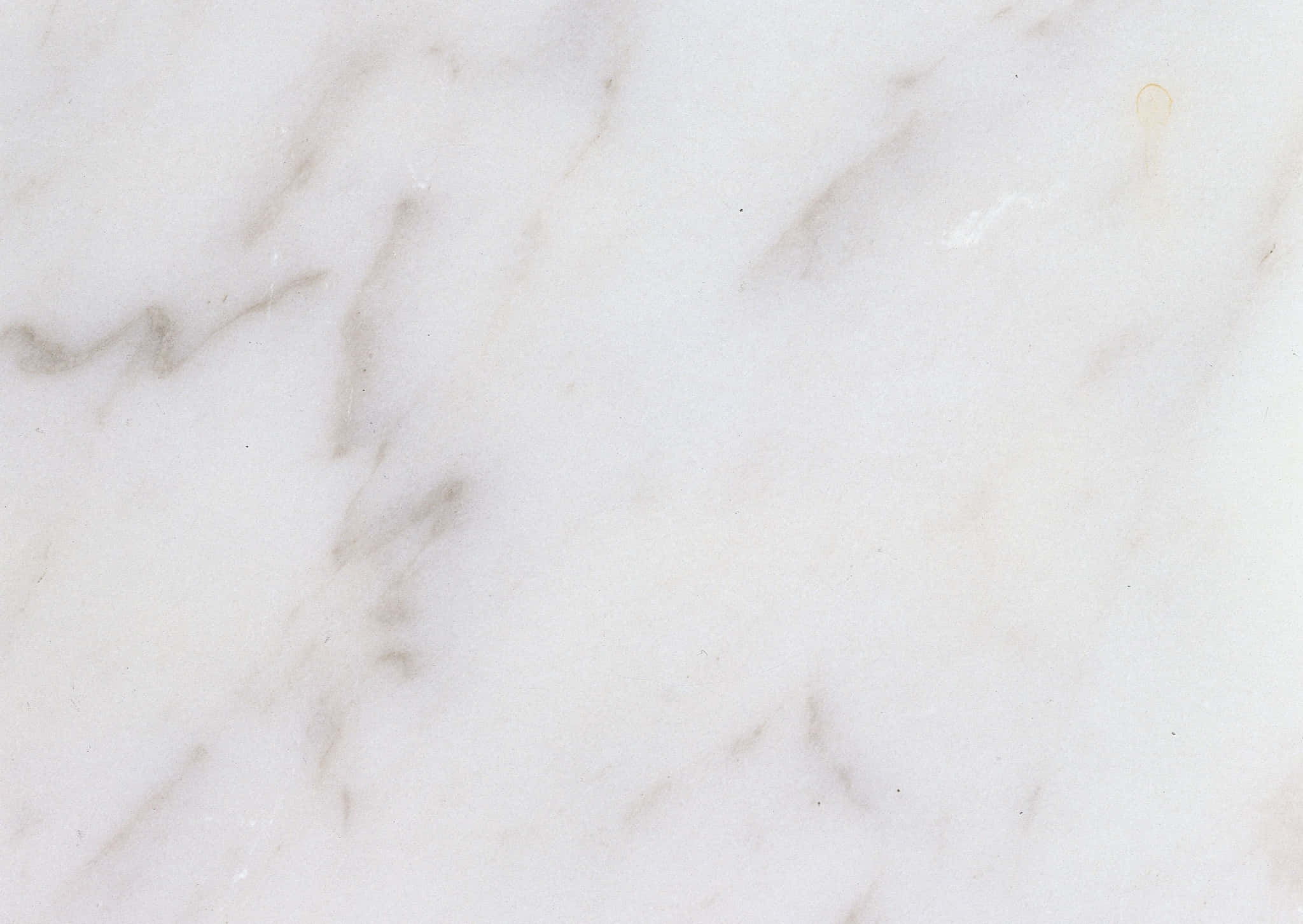Best Marble 桌布 壁紙 — 白色大理石特寫，帶有柔和灰色紋理和細微的自然瑕疵。