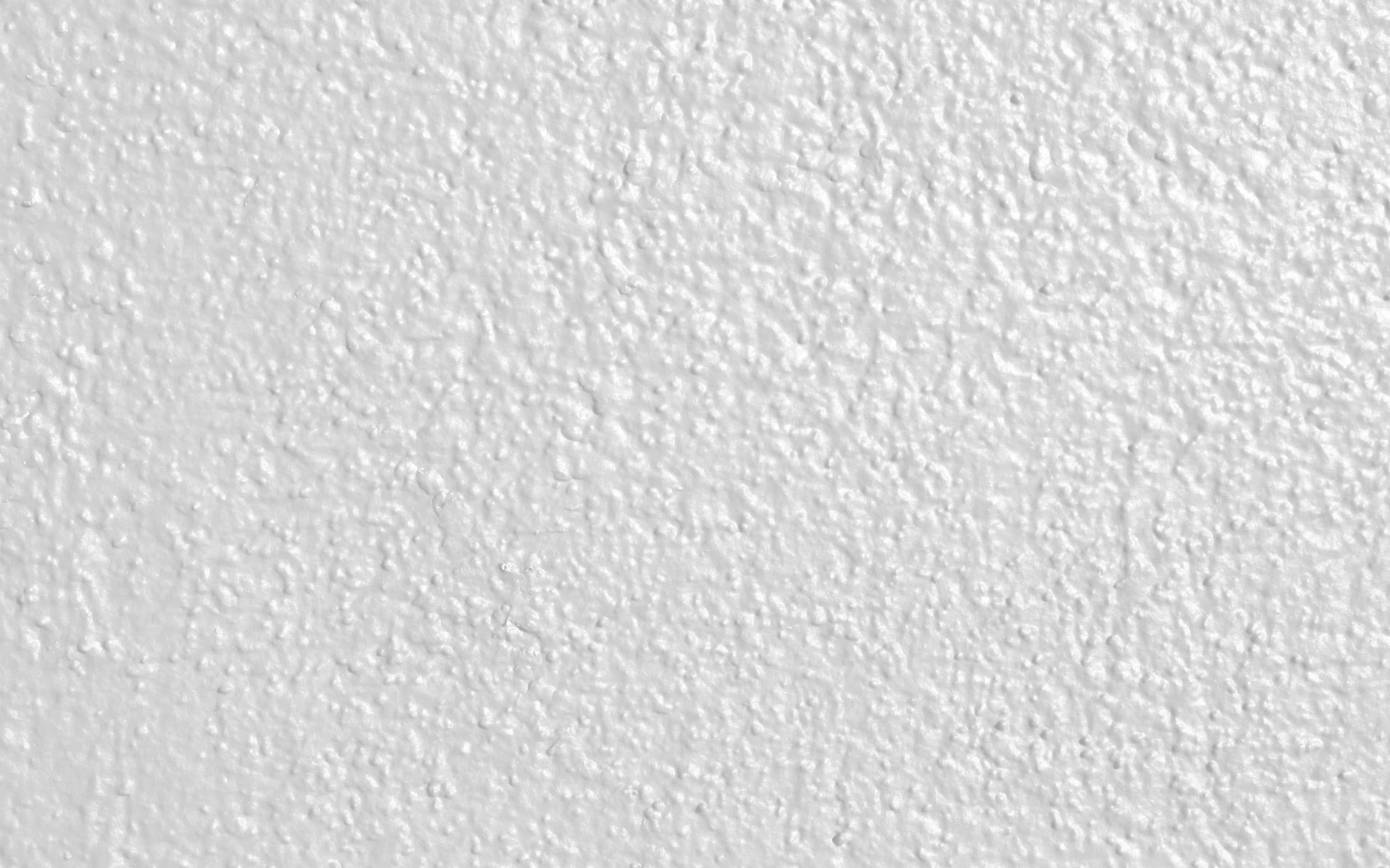 White Texture 桌布 壁紙 — 白色平滑灰泥牆的近距離特寫，帶有細微紋理和均勻光線。