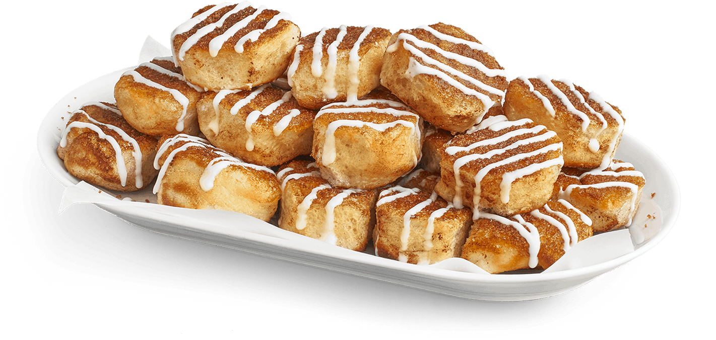 Desserts 桌布 壁紙 — 白色托盤上堆滿金黃色的肉桂捲，淋上白色糖霜，背景為黑色。