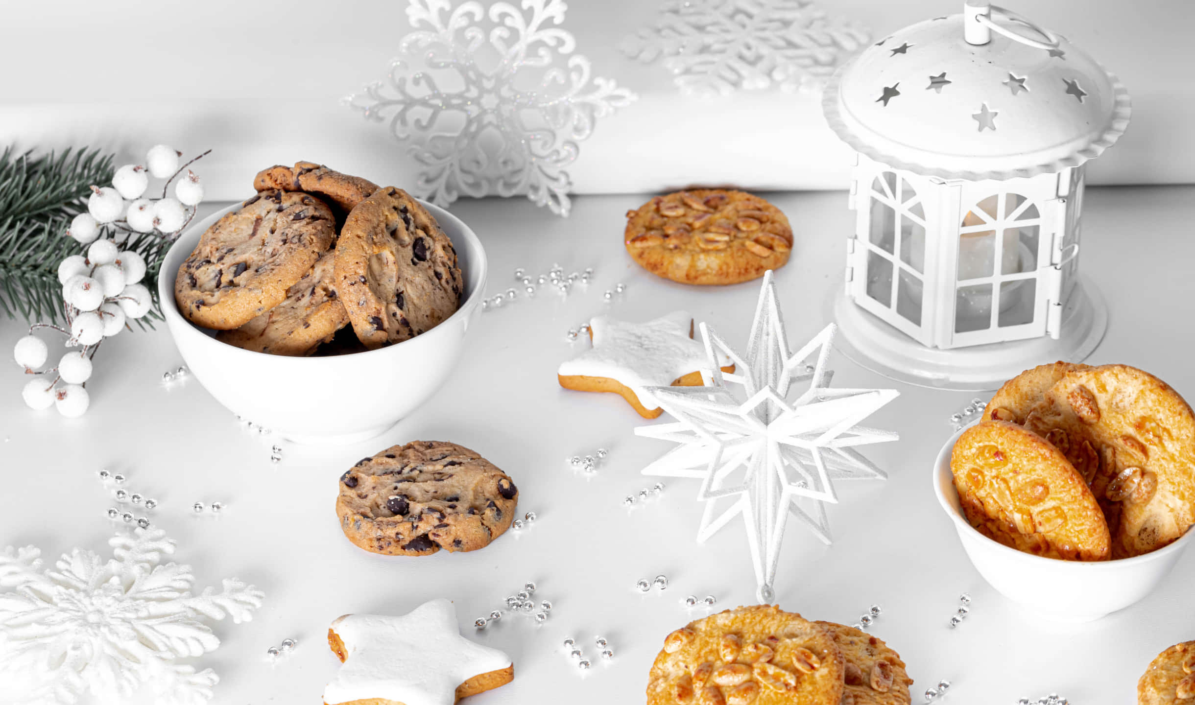 Cookies 桌布 壁紙 — 白色桌面上裝飾著節日餅乾、雪花和燈籠，營造出溫馨的節日場景。