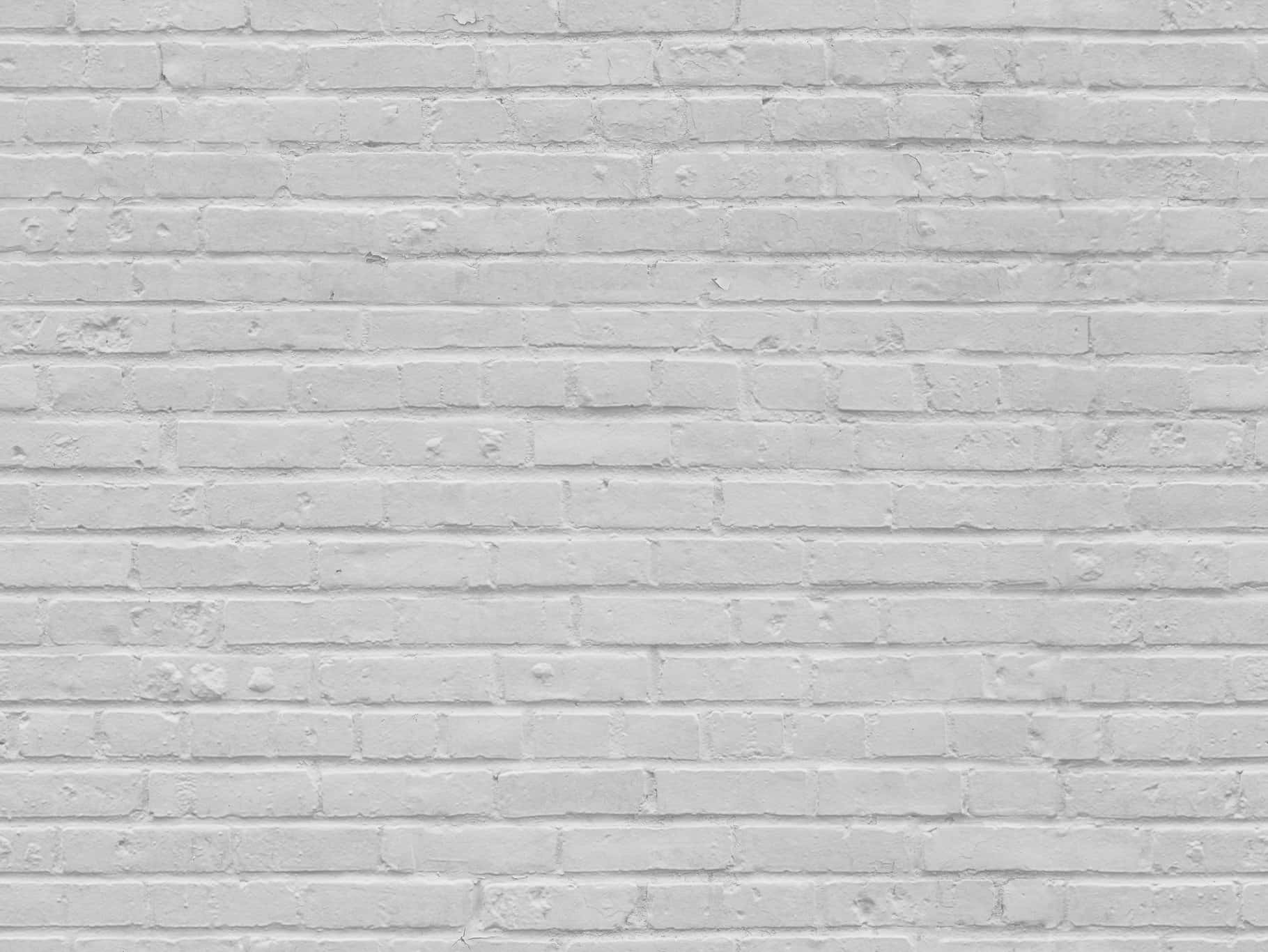 White Brick Wall 桌布 壁紙 — 白色油漆磚牆的特寫，可見砂漿線條和細微紋理。