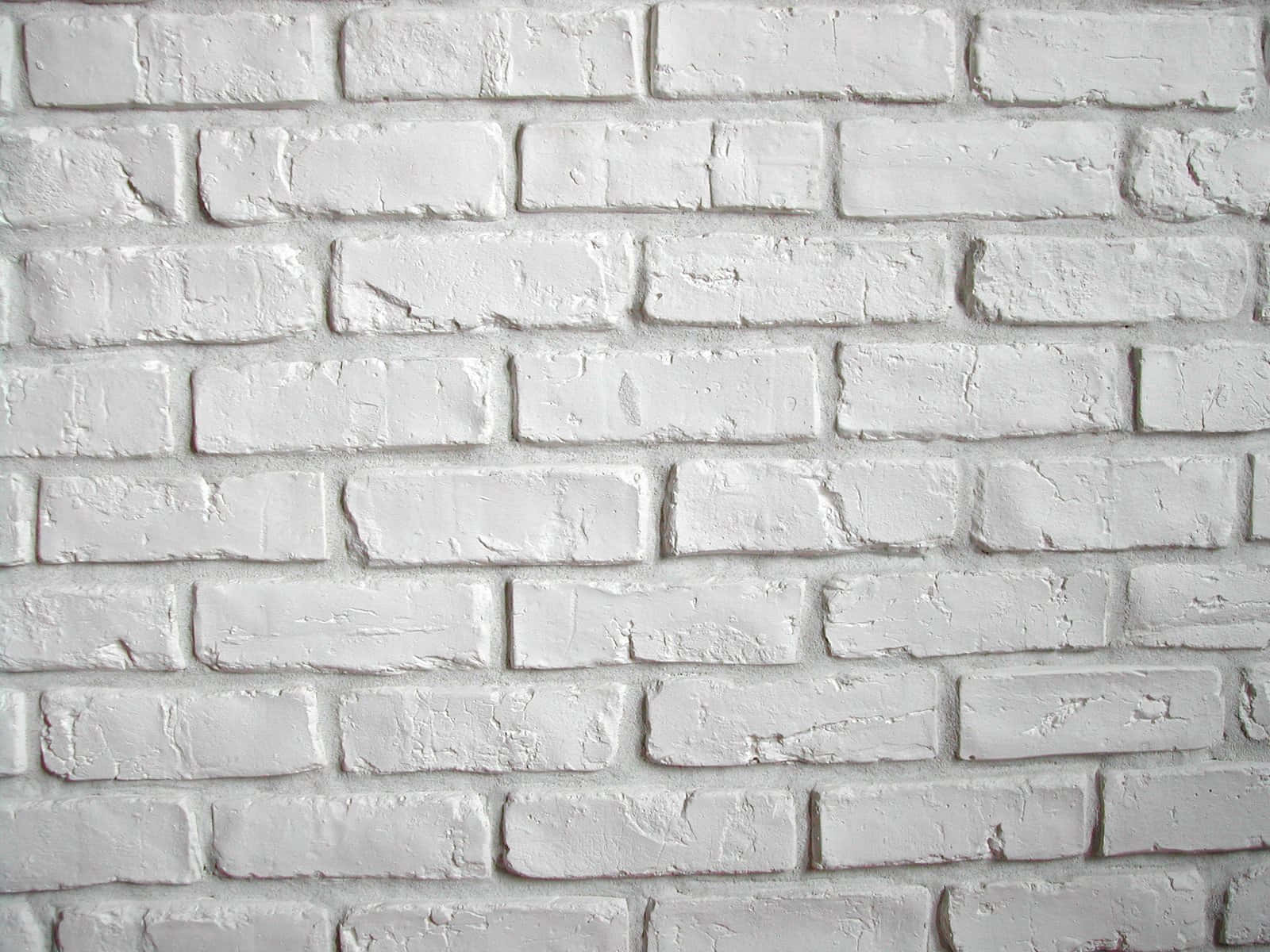Brick Wall 桌布 壁紙 — 白色油漆磚牆的特寫，顯示有紋理的砂漿和風化的表面細節。