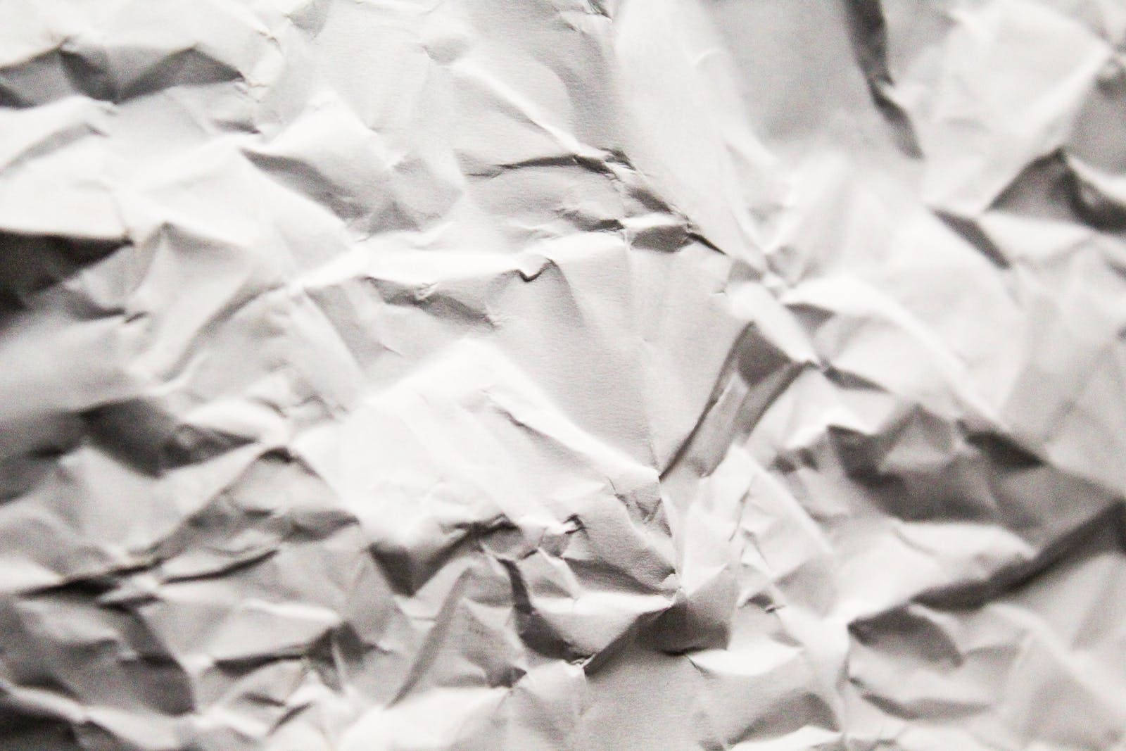Paper Texture 桌布 壁紙 — 白色皺紙的特寫，帶有柔和陰影和高光，營造出紋理化的抽象表面。