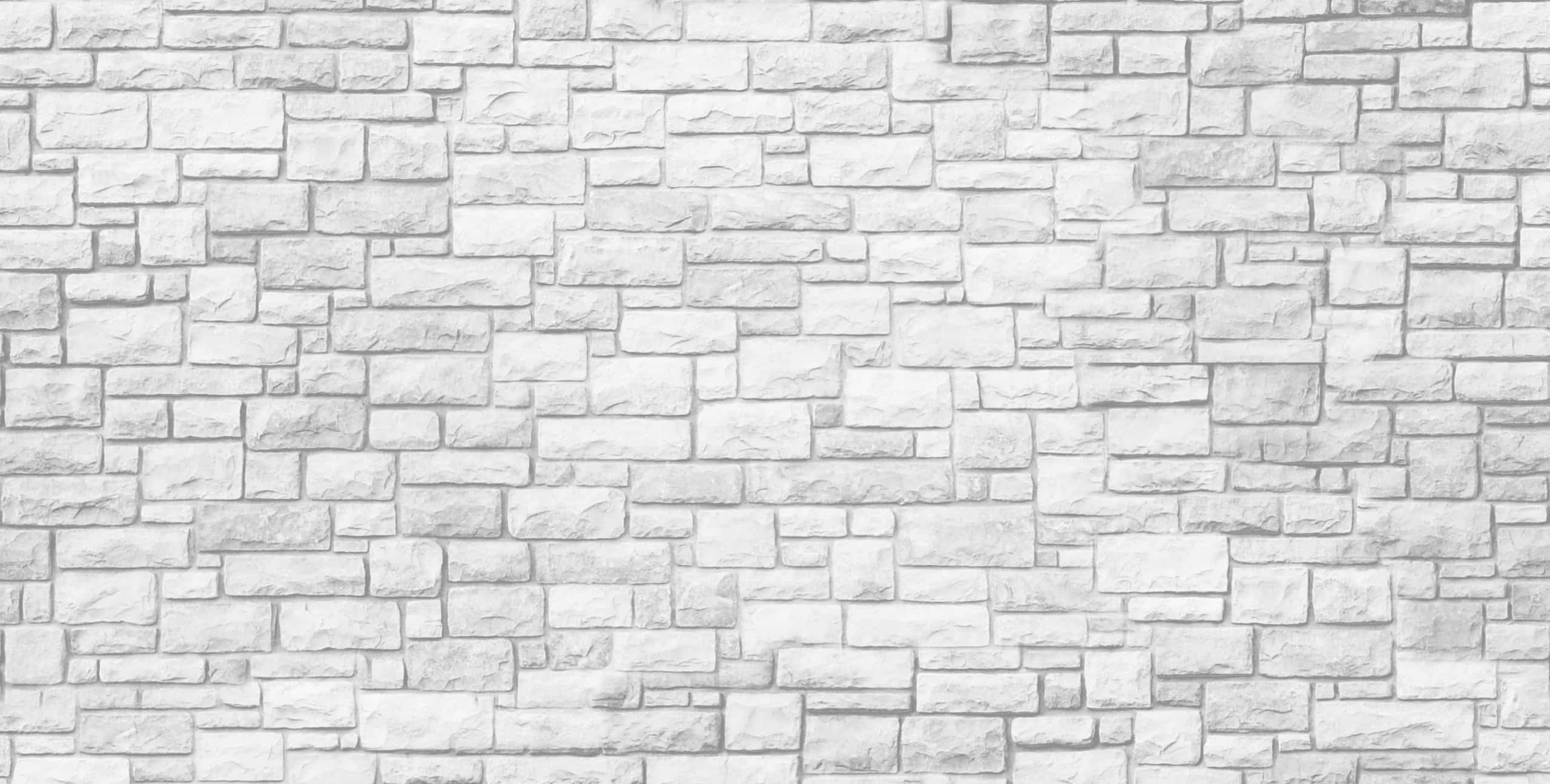 White Wall 桌布 壁紙 — 白色石磚牆的特寫，帶有微妙的灰色陰影和各種矩形形狀。