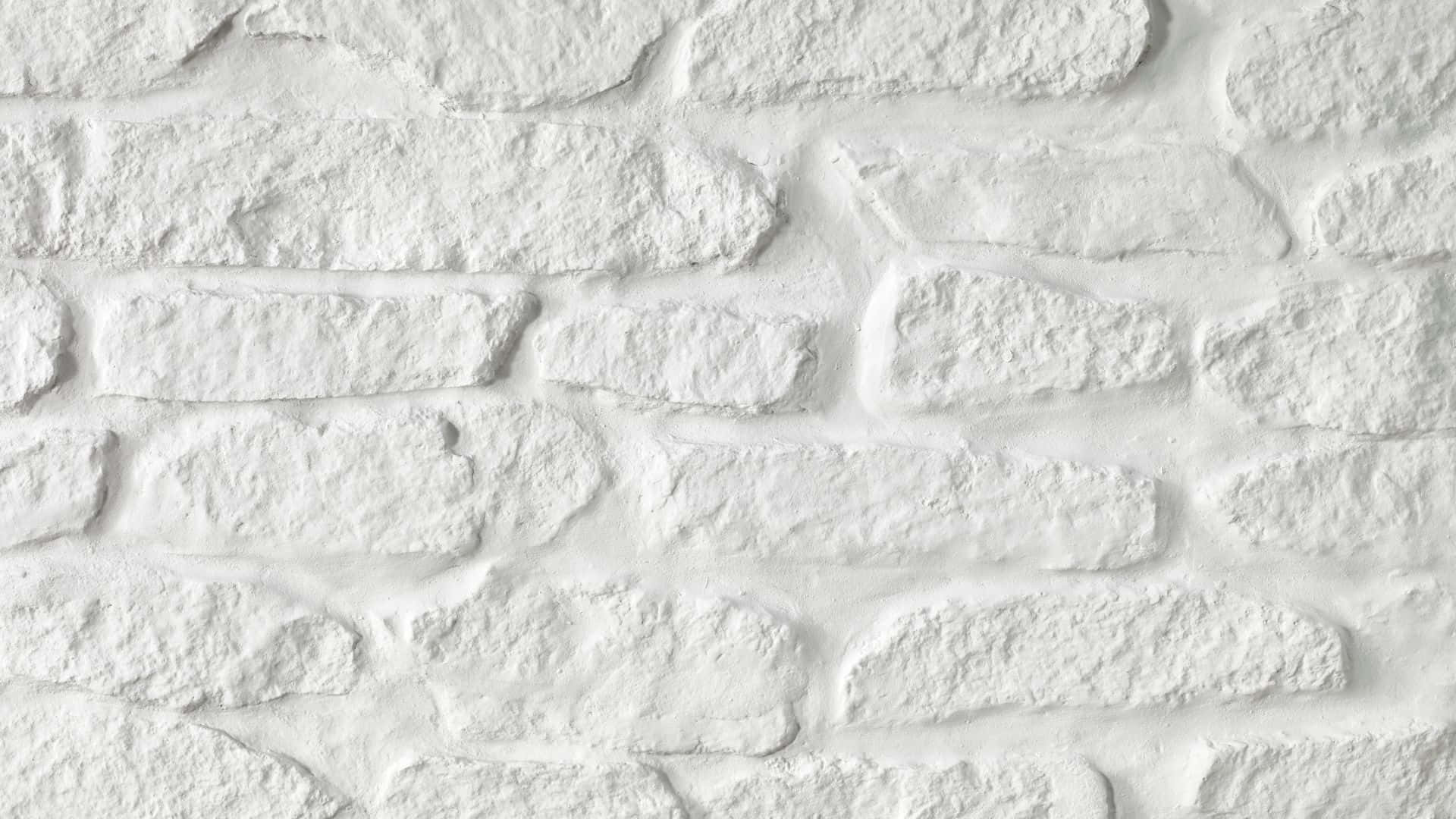White Brick 桌布 壁紙 — 白色石磚牆的特寫，紋理清晰，帶有柔和陰影和粗糙表面。