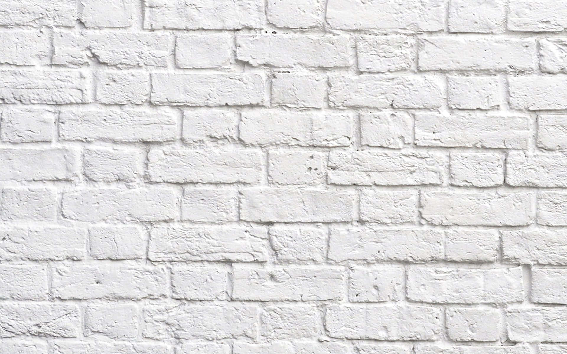 Brick Wall 桌布 壁紙 — 白色磚牆的特寫，在均勻光線下顯示出有紋理的砂漿和細微瑕疵。