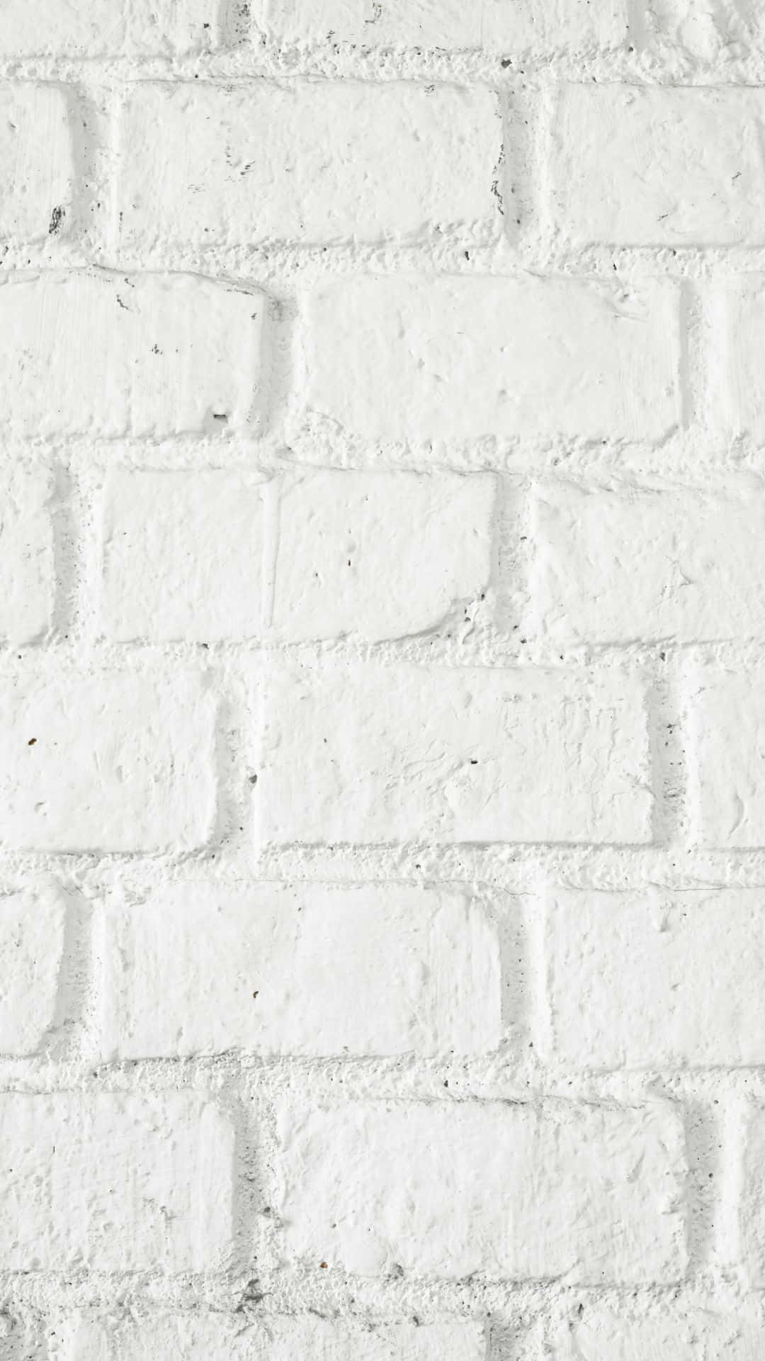 White Brick 桌布 壁紙 — 白色磚牆的特寫，顯示有紋理的砂漿線條和微妙的灰色斑點。
