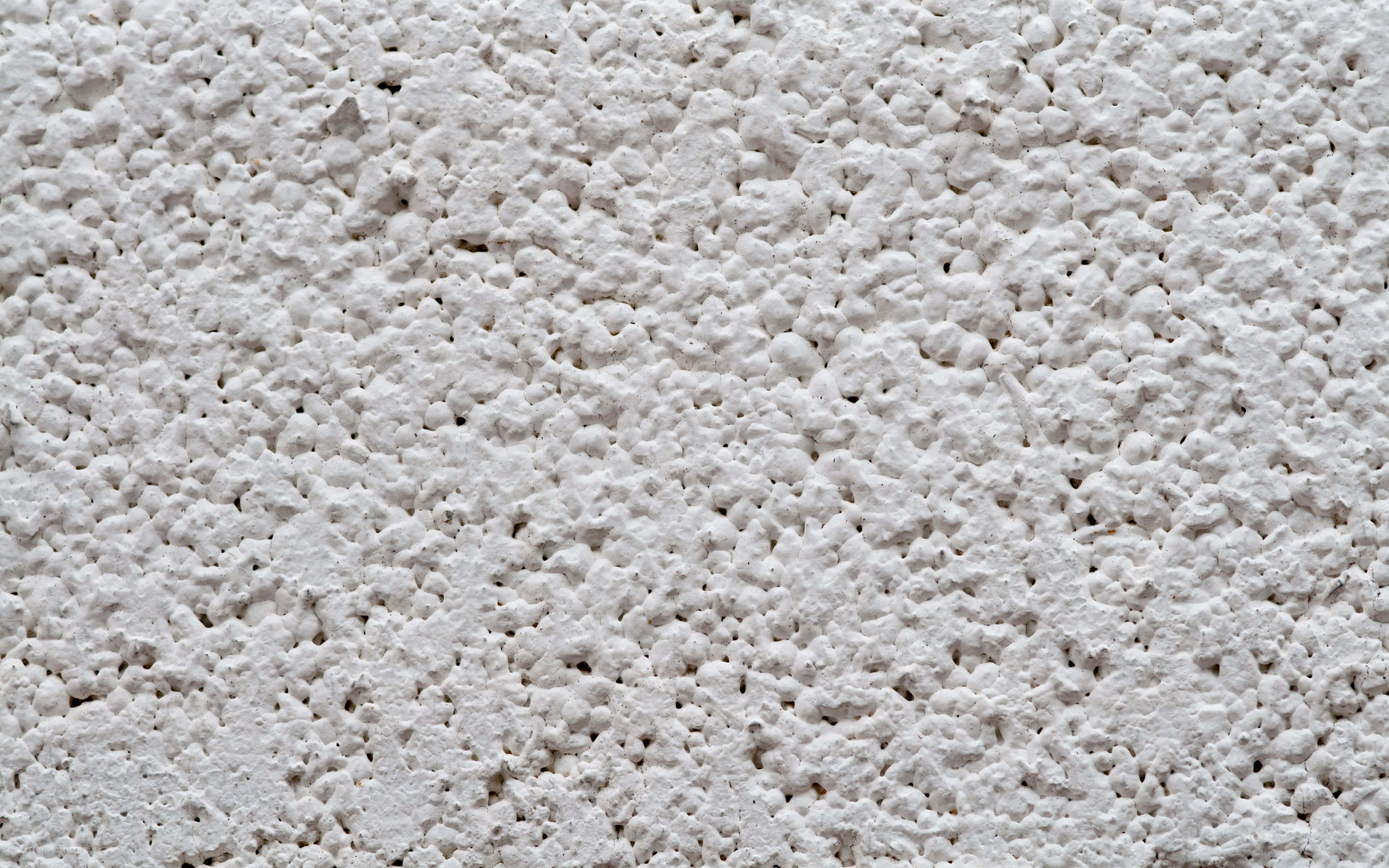 White Texture 桌布 壁紙 — 白色紋理牆壁的特寫，表面粗糙多孔，帶有細微陰影。