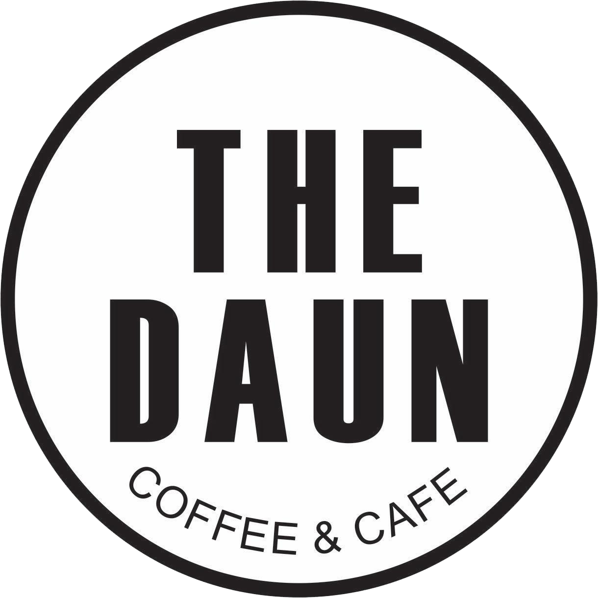 Daun 桌布 壁紙 — 白色背景上，簡約圓形標誌內有粗體黑色文字寫著 THE DAUN COFFEE & CAFE。