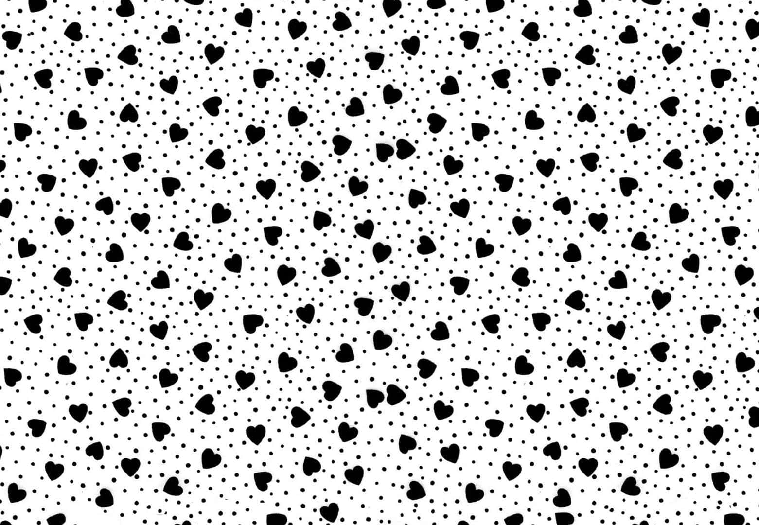 Black And White Dots 桌布 壁紙 — 白色背景上重複的黑色心形和圓點圖案，營造出俏皮浪漫的壁紙。