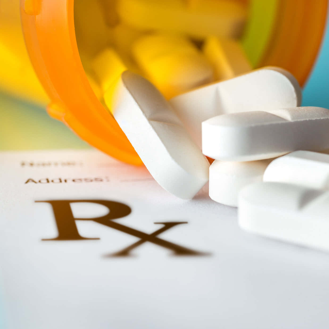pills 桌布 壁紙 — 白色藥丸從橙色處方藥瓶灑出，落在帶有顯著Rx符號的紙上。