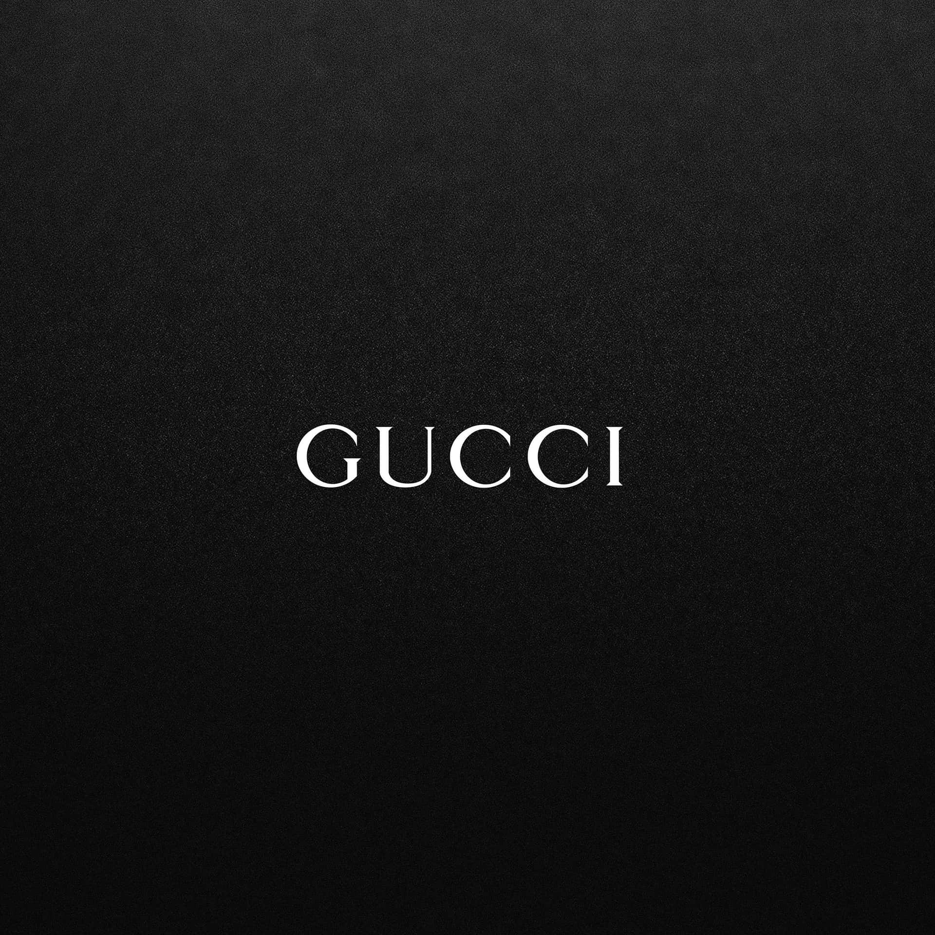 Gucci 桌布 壁紙 — 白色襯線字體「Gucci」居中顯示在帶有紋理的黑色布料背景上。