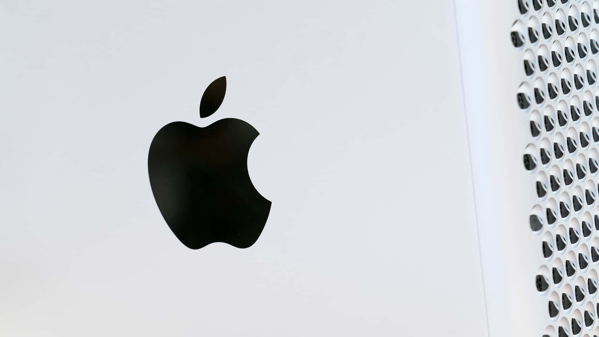 帶通風柵格的白色電腦上的黑色Apple標誌 — 蘋果標誌 GIF 壁紙