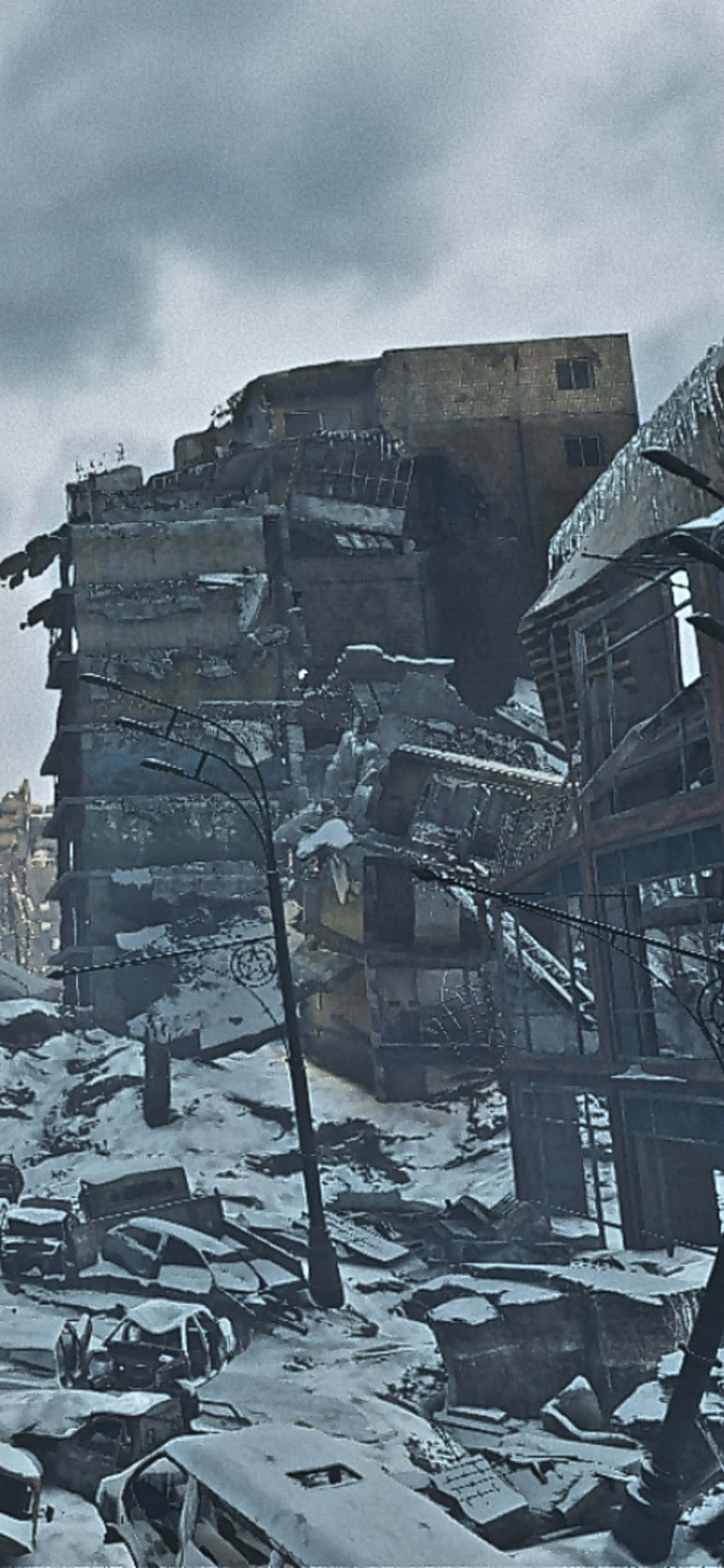 iPhone X Metro Exodus 桌布 壁紙 — 白雪覆蓋著一座被摧毀的城市景觀，到處是倒塌的建築物和報廢的汽車，天空陰沉。