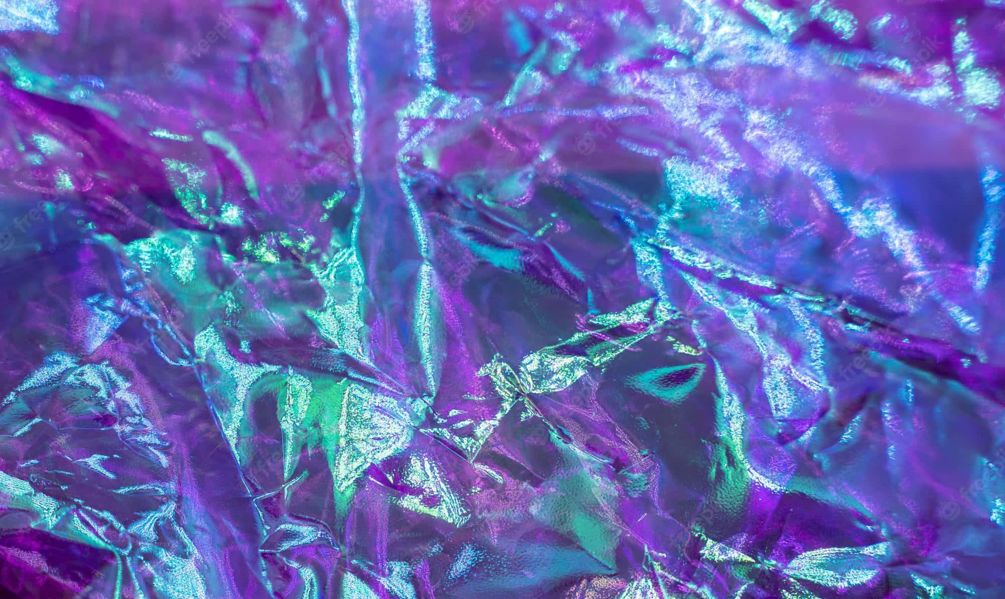 Neon Green And Purple 桌布 壁紙 — 皺巴巴的彩虹色箔紙特寫，帶有變化的紫色和藍綠色調，反射光線。