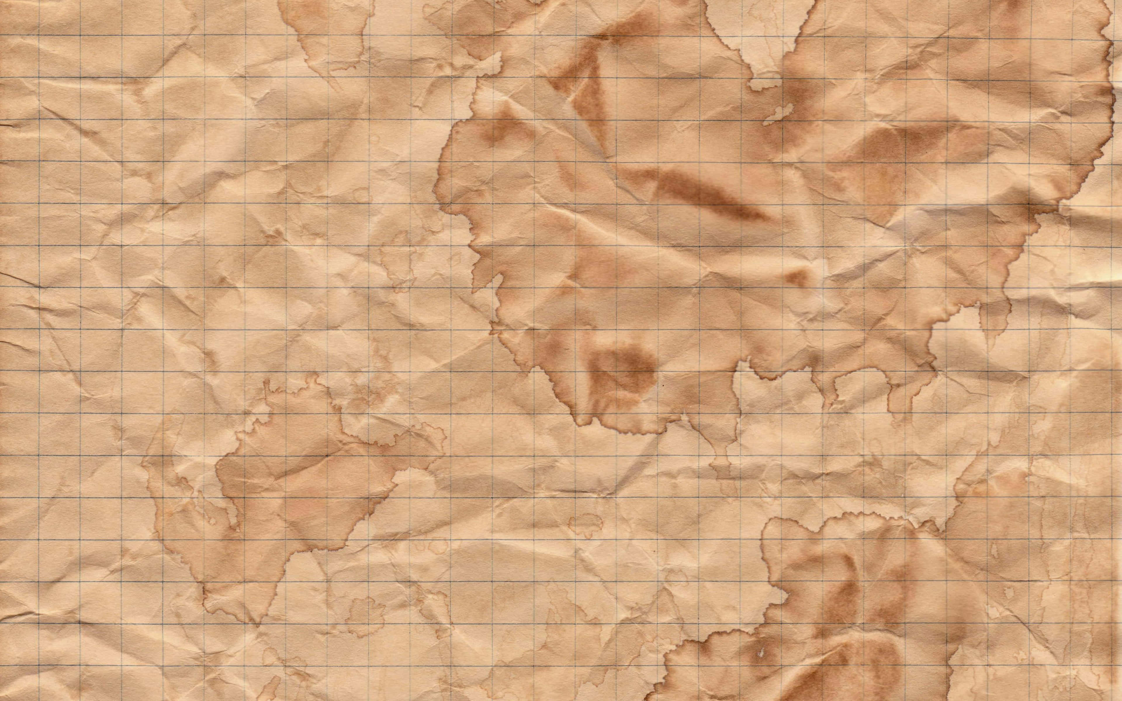 Old Paper Texture 桌布 壁紙 — 皺巴巴的米色羊皮紙上覆蓋著微弱的網格圖案，顯示出自然的摺痕和污漬。