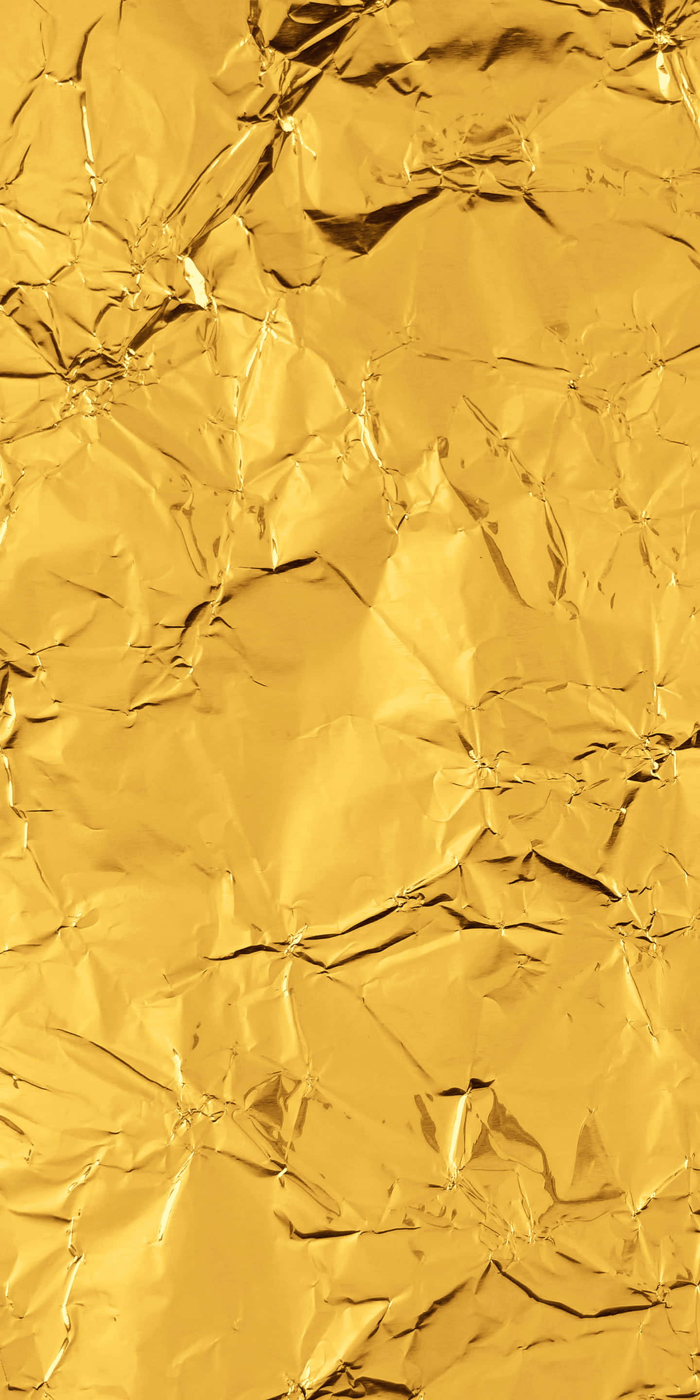 Shiny Gold 桌布 壁紙 — 皺巴巴的金色箔紙特寫，帶有銳利的摺痕和反光高光。