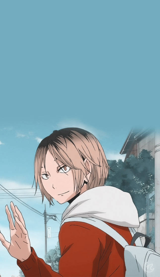 Kenma Kozume 桌布 壁紙 — 短棕髮、身穿紅色連帽衫的動漫角色，在明亮的藍天和背景中的城市建築前愉快地揮手。