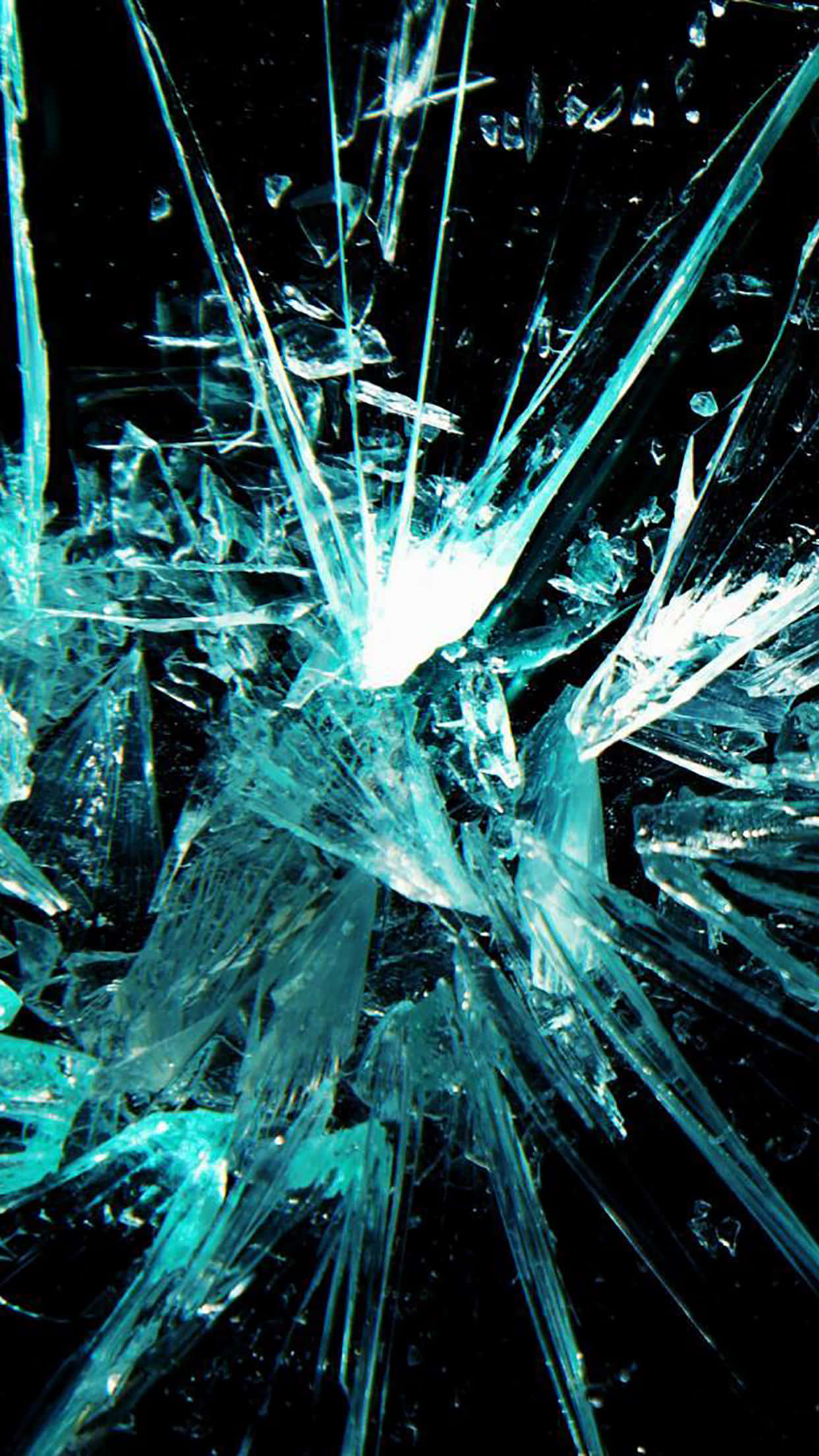 Fracture Glass 桌布 壁紙 — 破碎的玻璃表面，尖銳的藍綠色碎片從明亮的中心點向黑色背景輻射。