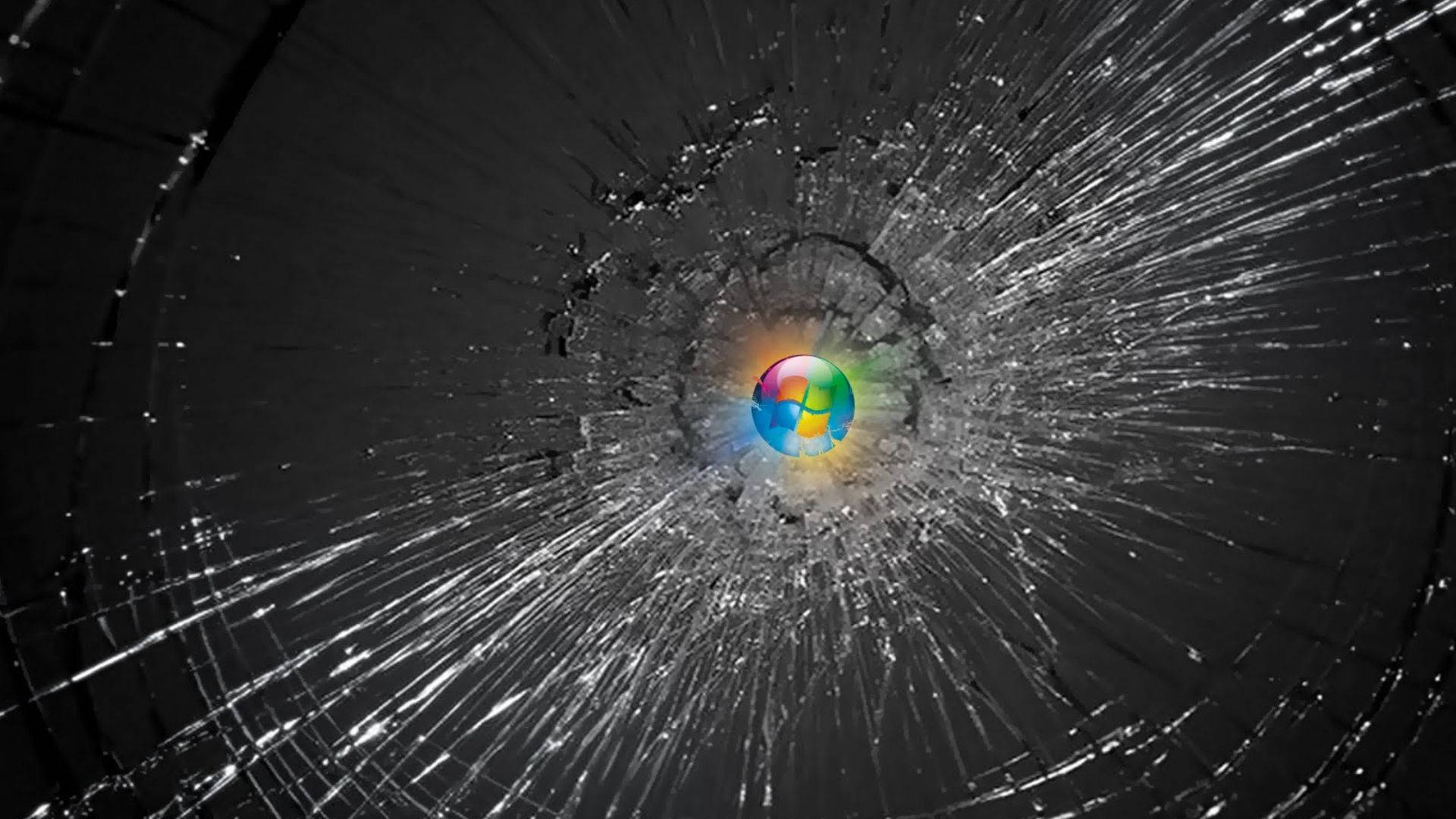 Computer Screen 桌布 壁紙 — 破碎的玻璃表面從中央的彩色地球標誌向外輻射裂紋。