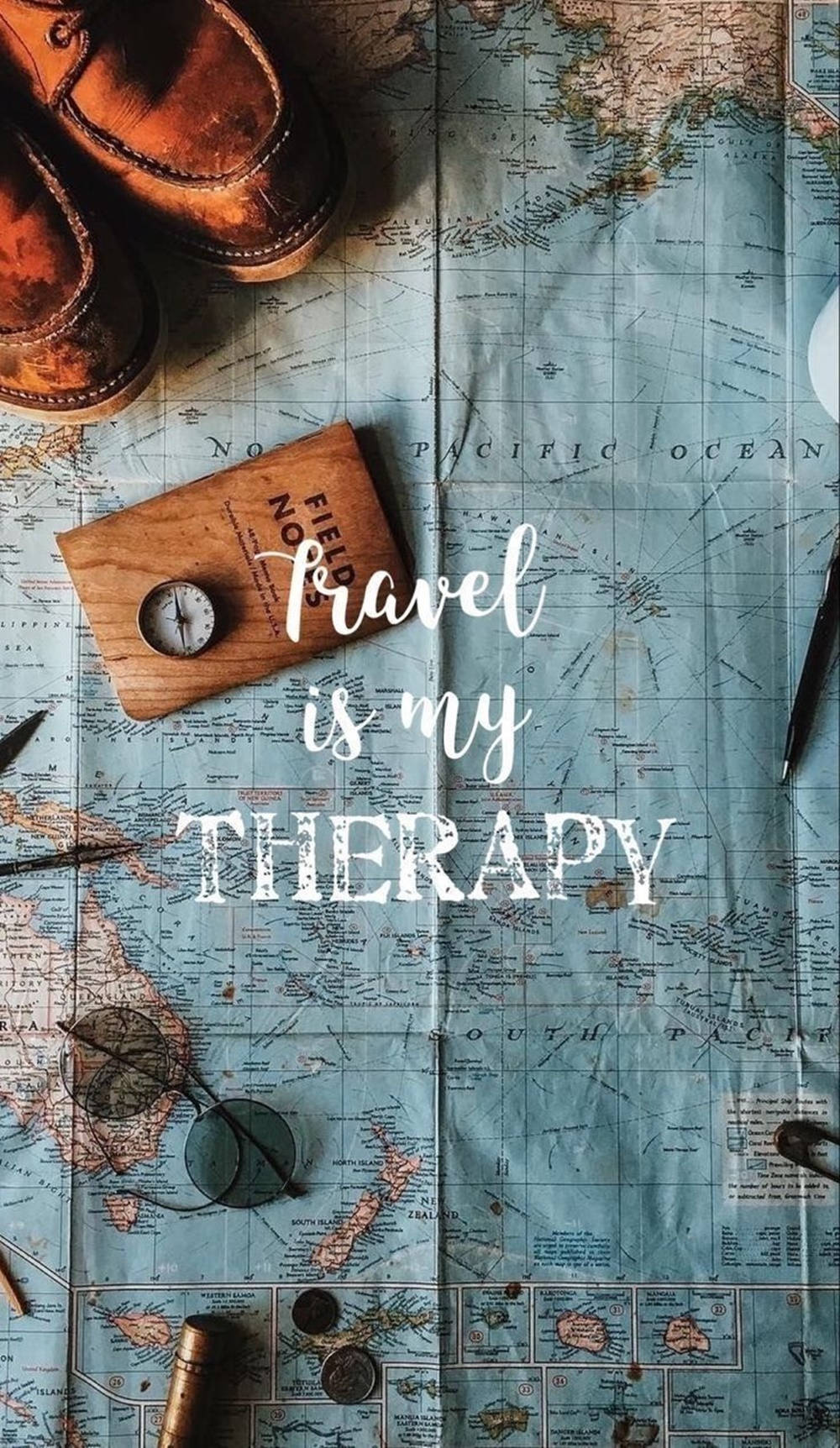 Map 桌布 壁紙 — 破舊皮鞋、指南針和眼鏡放在一張寫有 travel is my therapy 的復古地圖上。