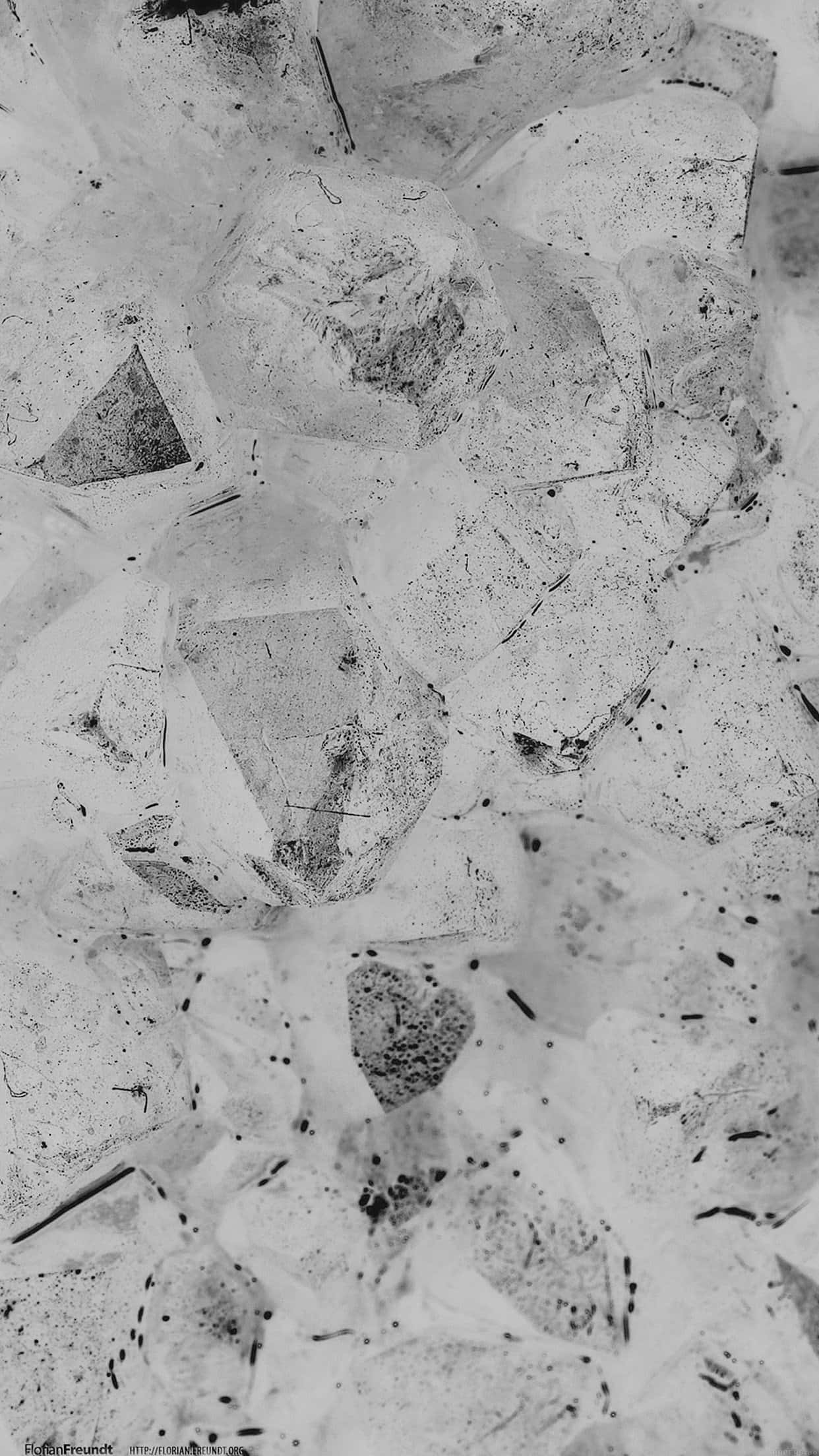 Granite 桌布 壁紙 — 碎裂冰塊的單色特寫，帶有嵌入的暗色斑點和鋒利的晶體邊緣。