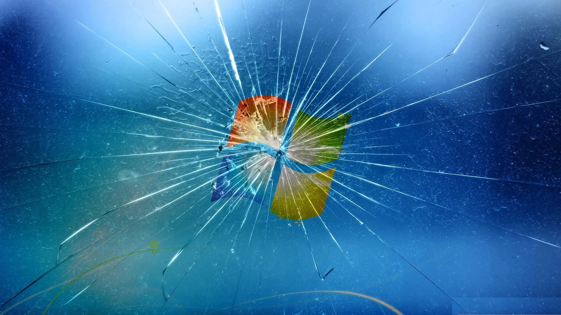 Lcd 桌布 壁紙 — 碎裂玻璃效果覆蓋Windows標誌，裂紋在藍色漸變背景上向外擴散。