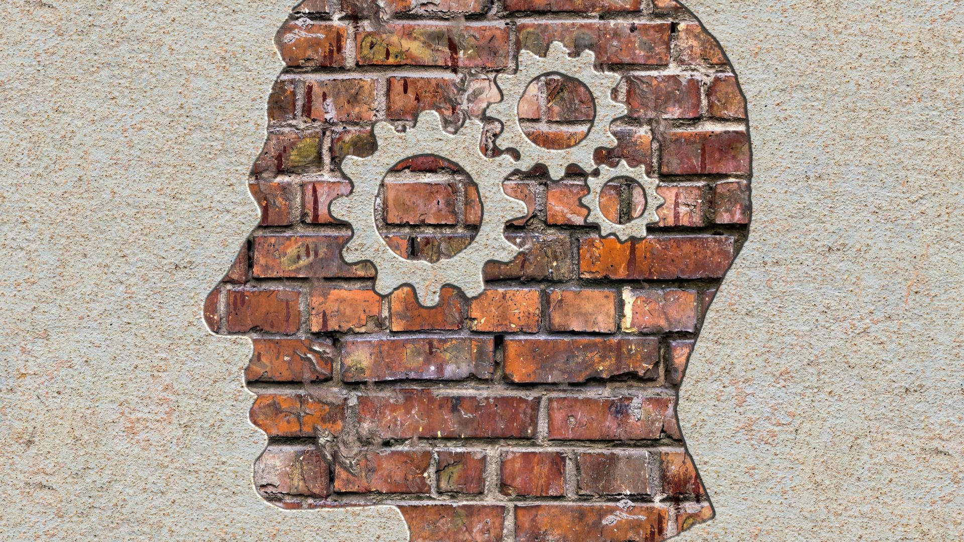 mind 桌布 壁紙 — 磚牆被切割成人類頭部剪影，金屬齒輪嵌入輪廓中。