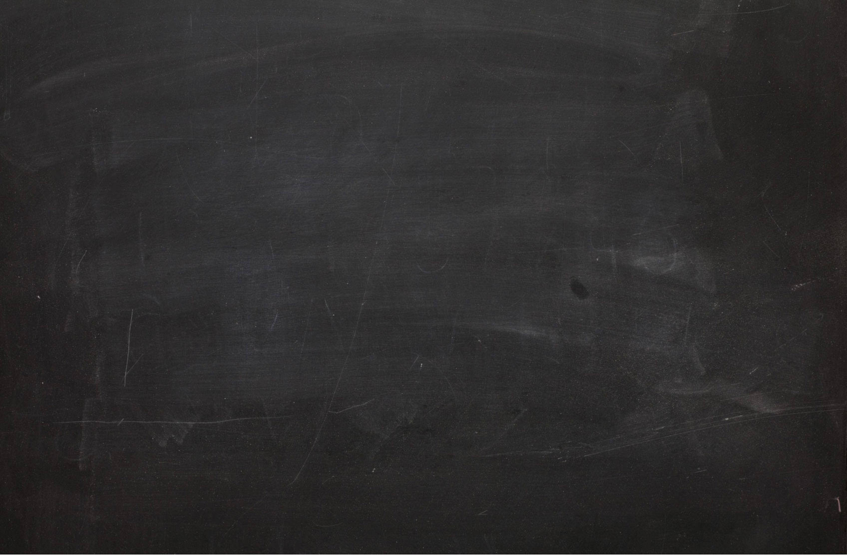 Chalkboard 桌布 壁紙 — 磨損的黑色黑板表面特寫，帶有淡淡的白色粉筆污跡和刮痕。