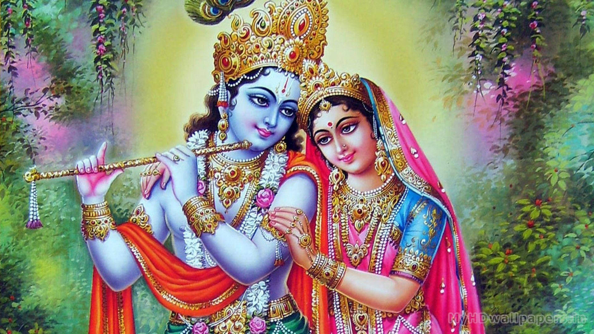 radha krishna HD 桌布 壁紙 — 神聖情侶克里希納和拉達，佩戴金色珠寶和鮮豔服飾，在茂盛的花藤中於光芒四射的光輝下擁抱。