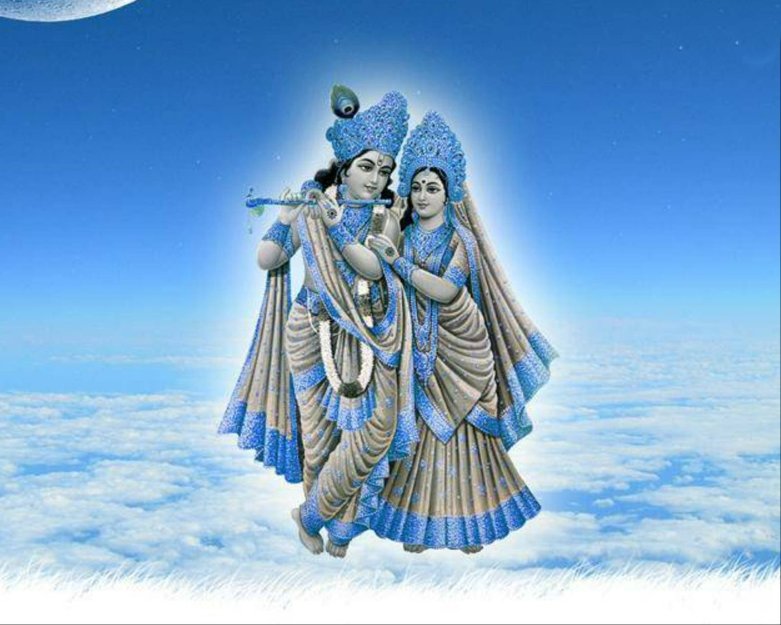 Hindu God 桌布 壁紙 — 神聖的克里希納和拉達在彎月下漂浮在雲端之上，穿著華麗的藍色和米色服飾。