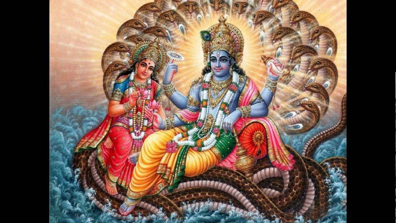 Vishnu 桌布 壁紙 — 神聖的夫婦佩戴著鮮豔的珠寶和皇家服飾，優雅地坐在一條從翻騰海浪中升起的多頭蛇上。