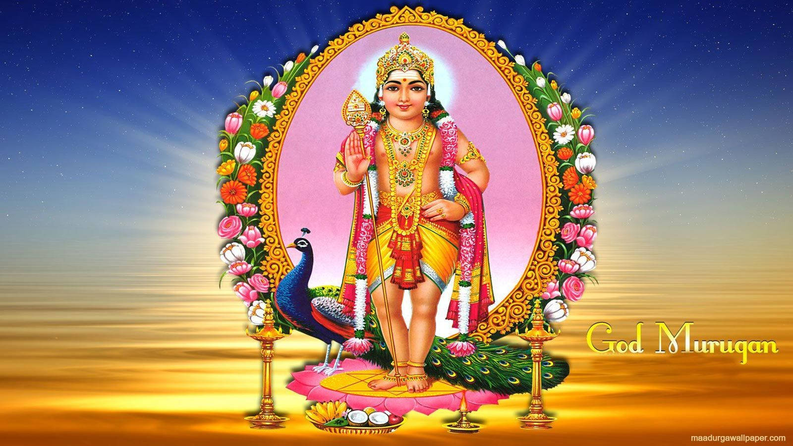 Hindu God 桌布 壁紙 — 穆魯干神身穿金色盔甲和花環，在華麗的橢圓形框架內，以星空漸變為背景，光彩奪目。