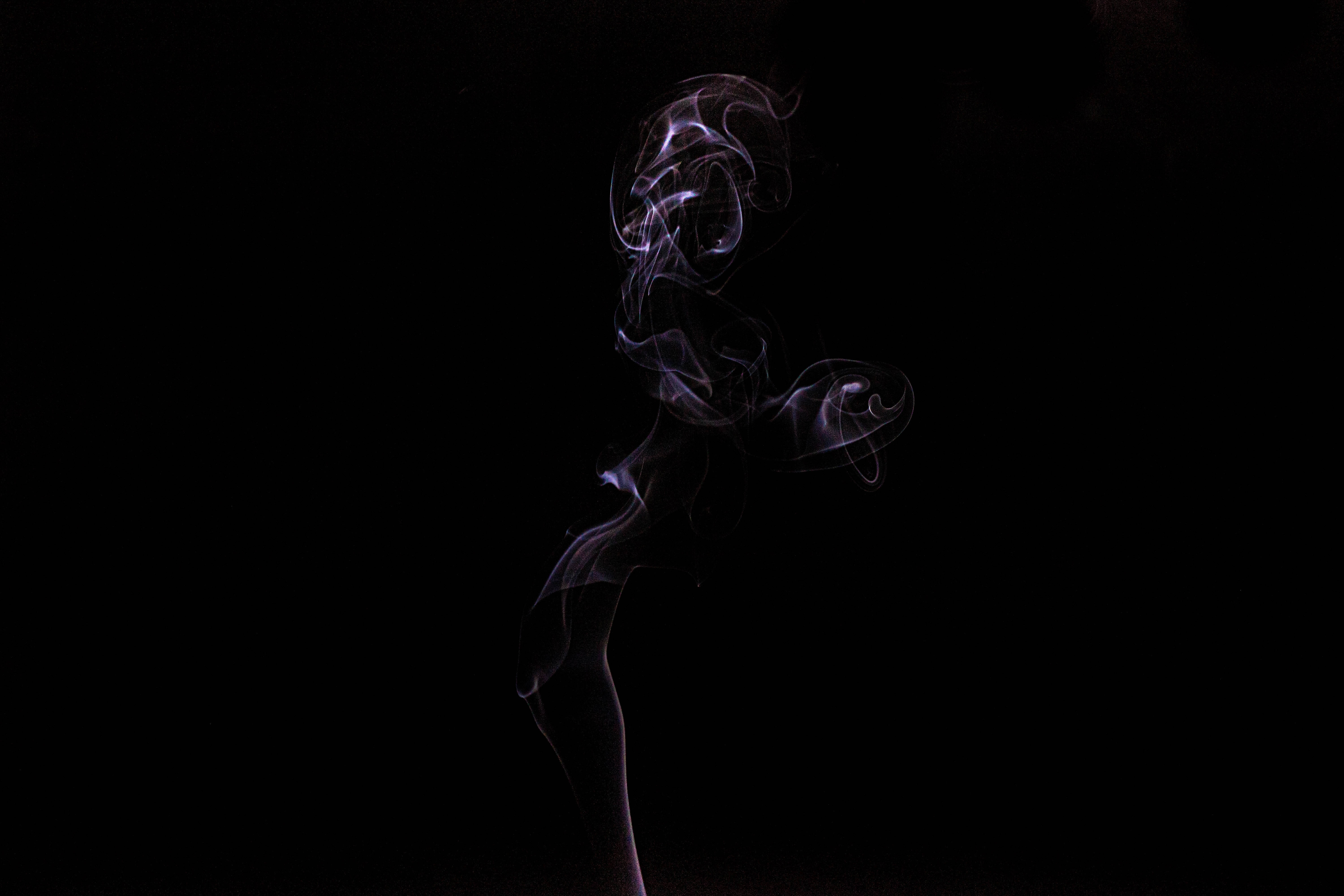 黑色 桌布 壁紙 — 空靈的紫色煙霧在純黑色背景上優雅地旋轉，形成迷人的抽象舞蹈。