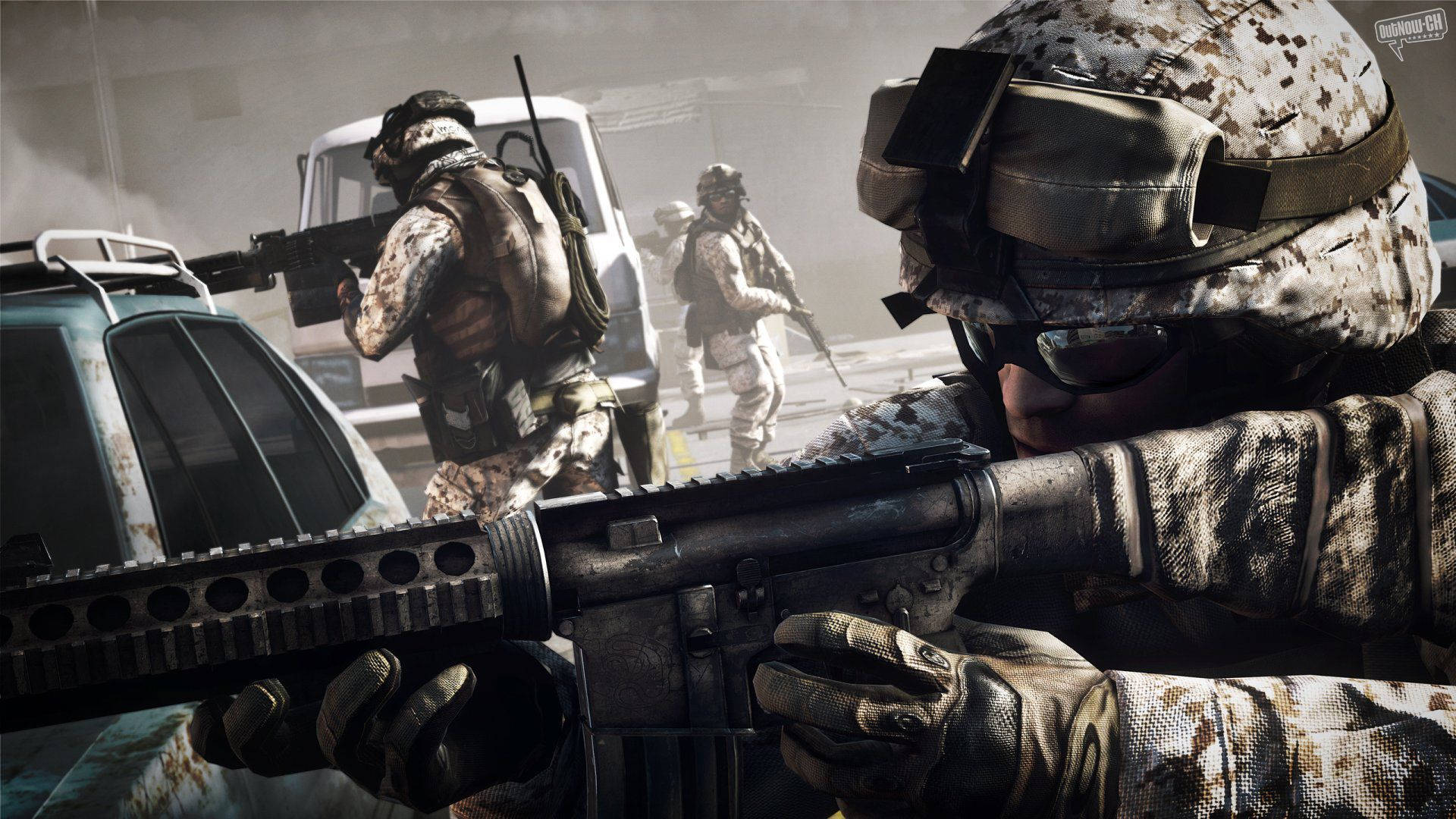 桌布 壁紙 — 穿著沙漠迷彩的士兵在塵土飛揚的城市戰場上前進，背景有車輛和煙霧。
