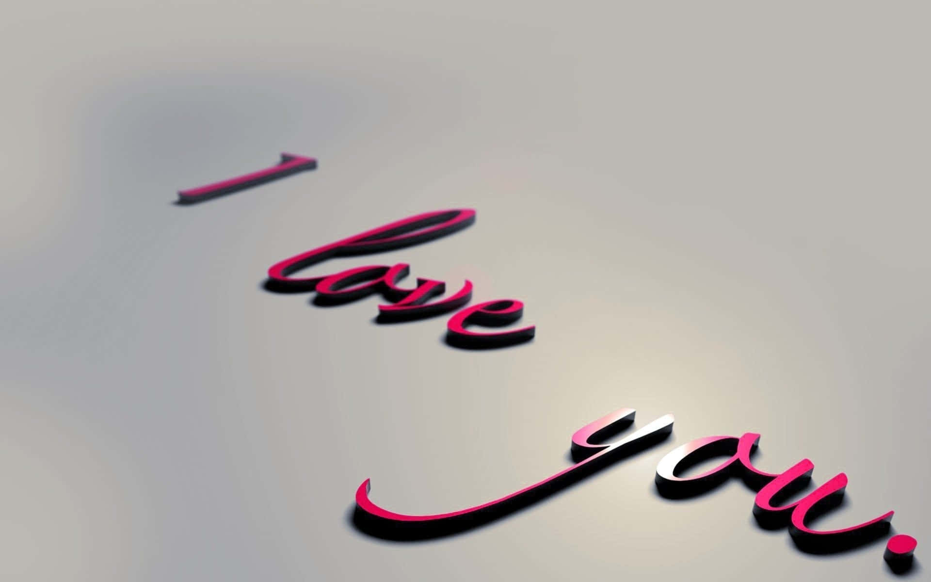 Greetings 桌布 壁紙 — 立體粉紅色草書字母拼出「I love you」，在柔和的灰色漸層背景上對角漂浮。