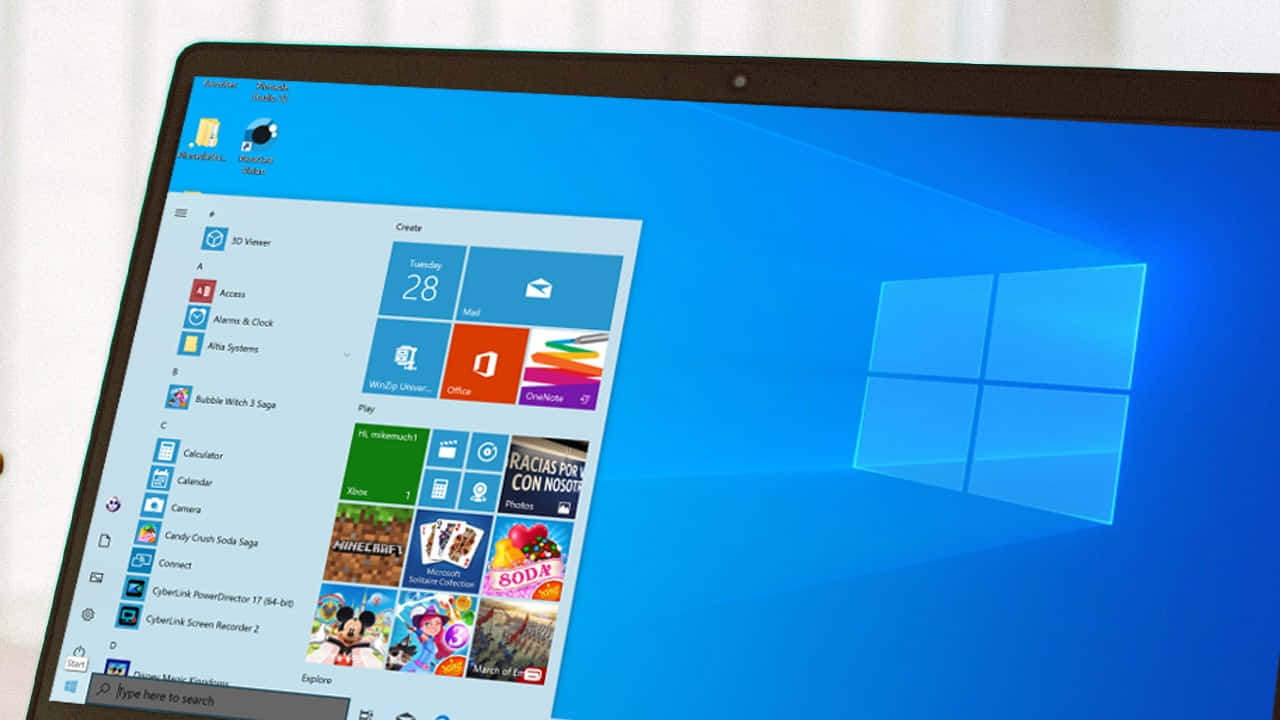 Windows Computer 桌布 壁紙 — 筆記型電腦螢幕顯示Windows 10開始功能表，帶有應用程式磚和藍色Windows標誌背景。